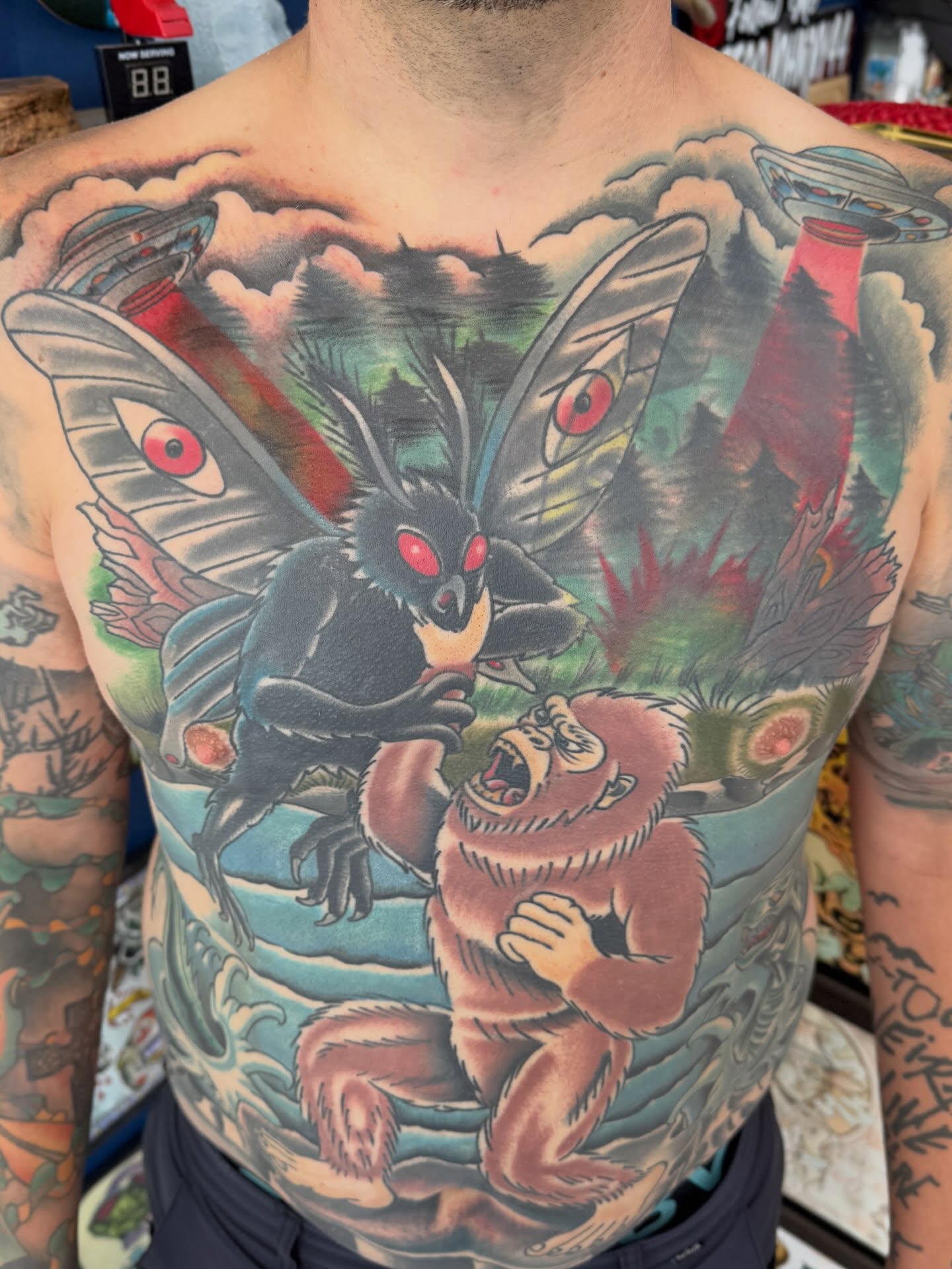 Moth and ape American traditional tattoo on the chest by Trent Parsley