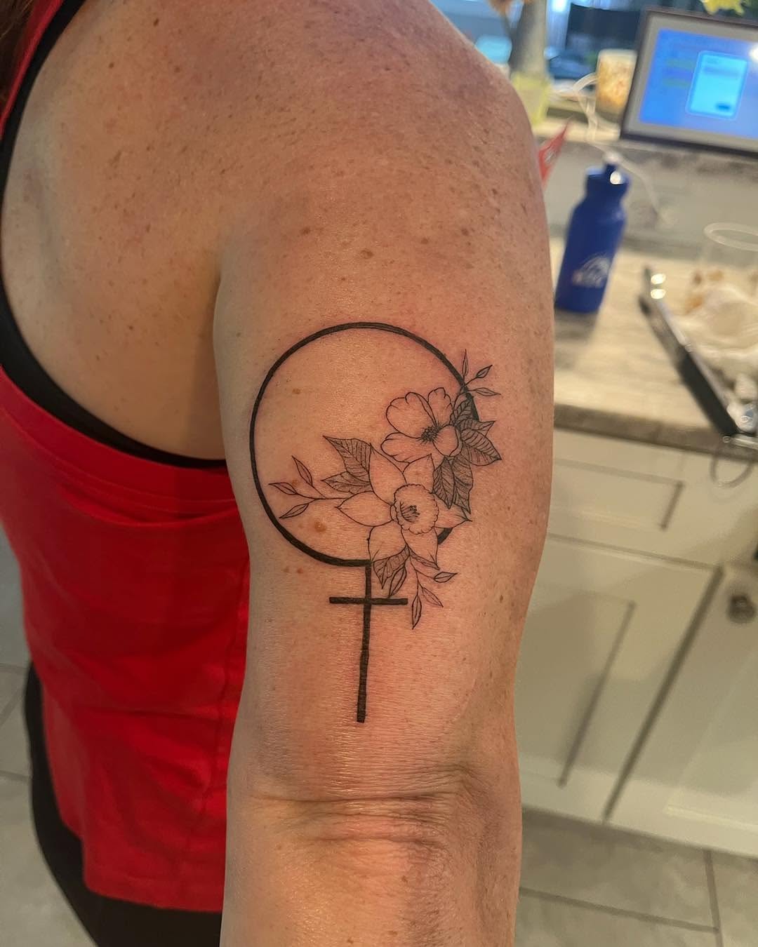 Female symbol with flowers fine line tattoo on the forearm by Malissa