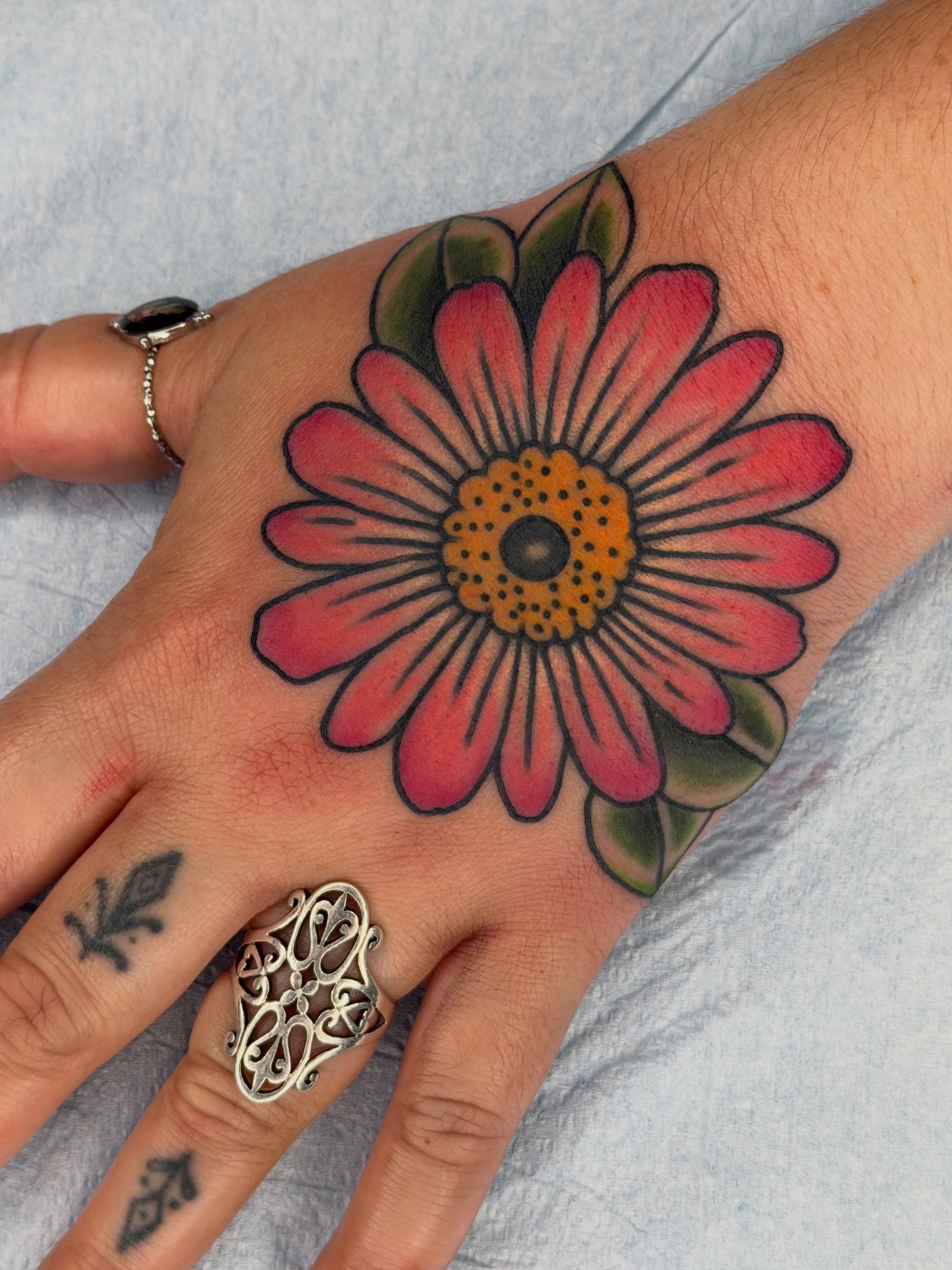 Flower American traditional tattoo on the hand by Beeker, Bellingham, Washington