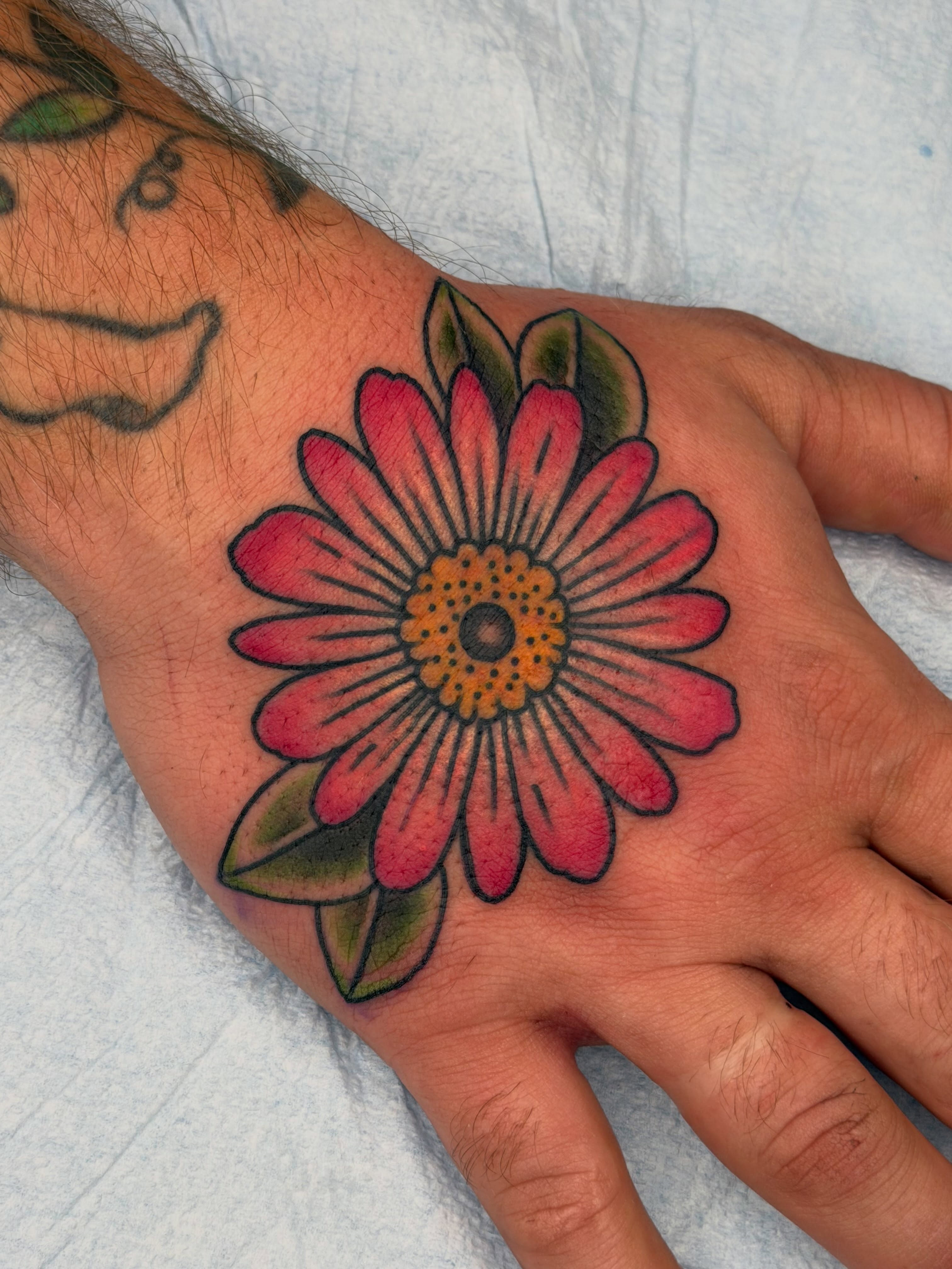 Flower American traditional tattoo on the hand by Beeker, Bellingham, Washington
