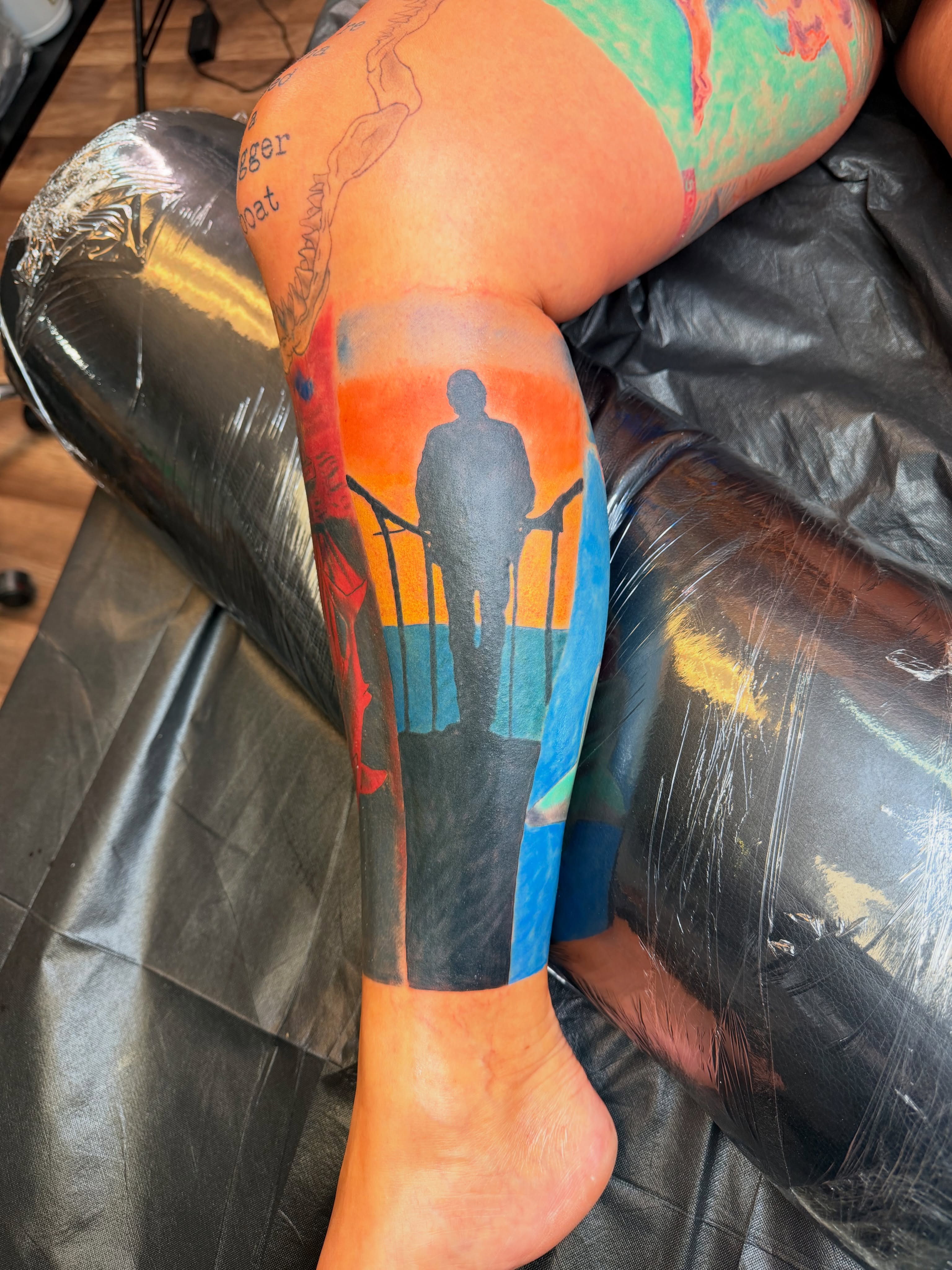 Silhouette of person standing realism tattoo on the leg by Rain David