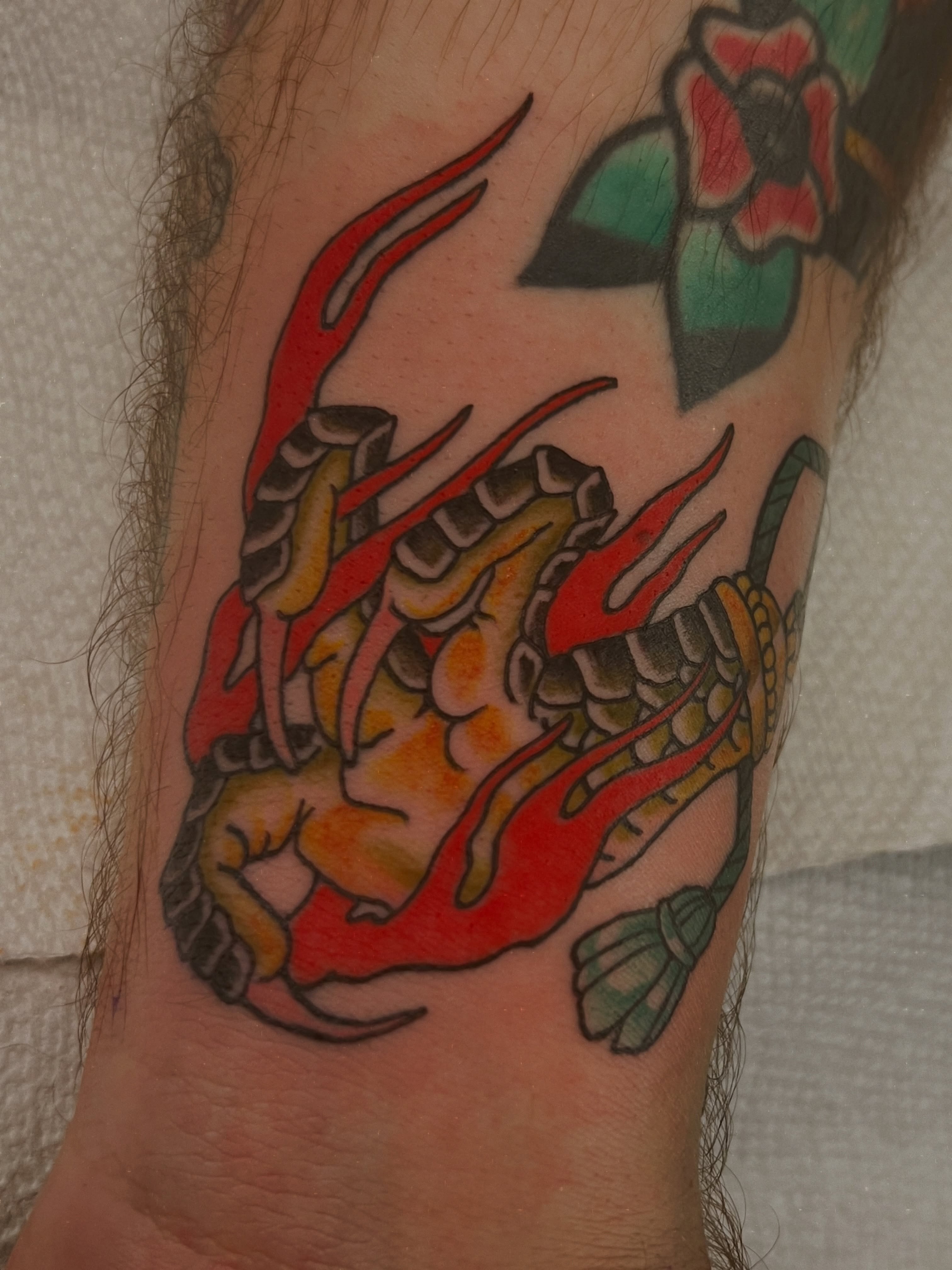 Dragon American traditional tattoo on the forearm by Andrea Patterson
