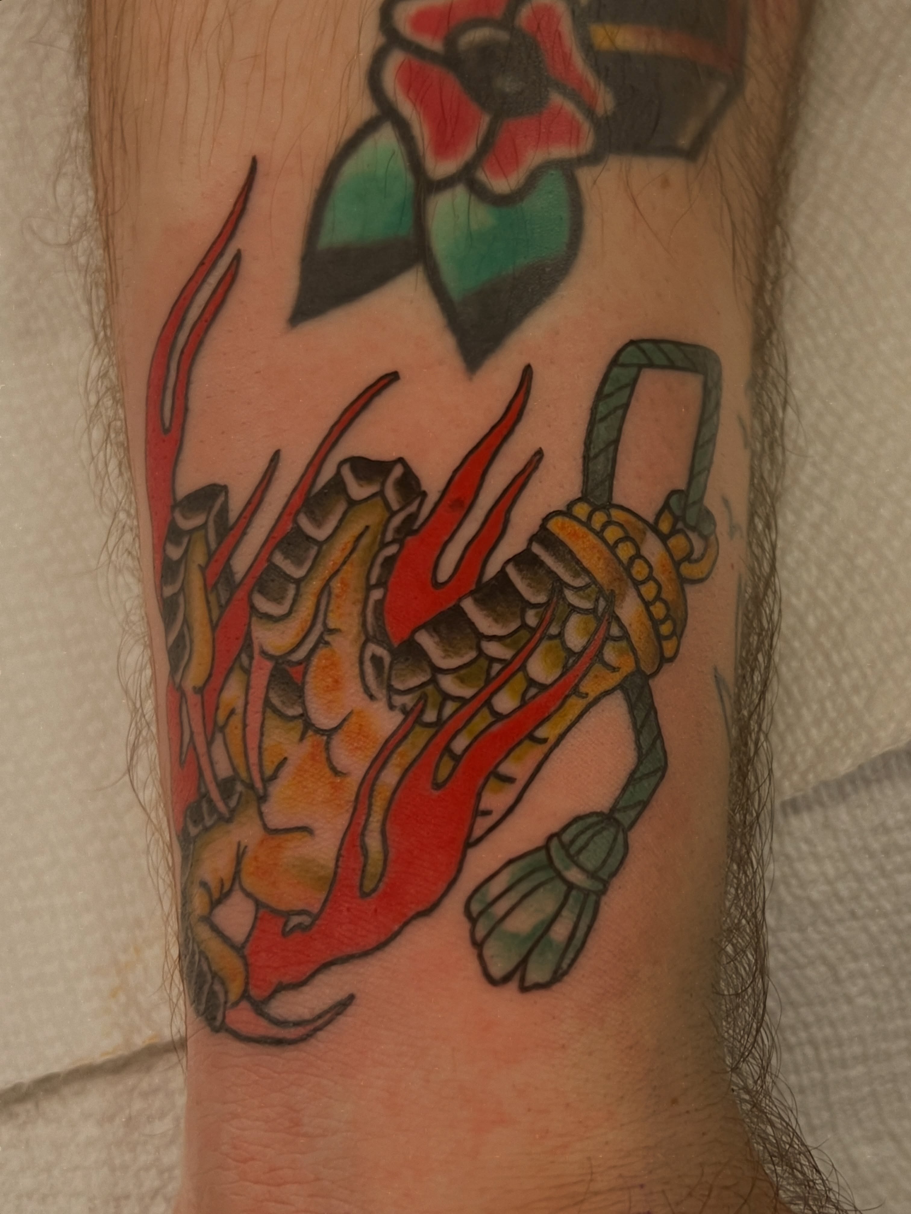Dragon American traditional tattoo on the forearm by Andrea Patterson