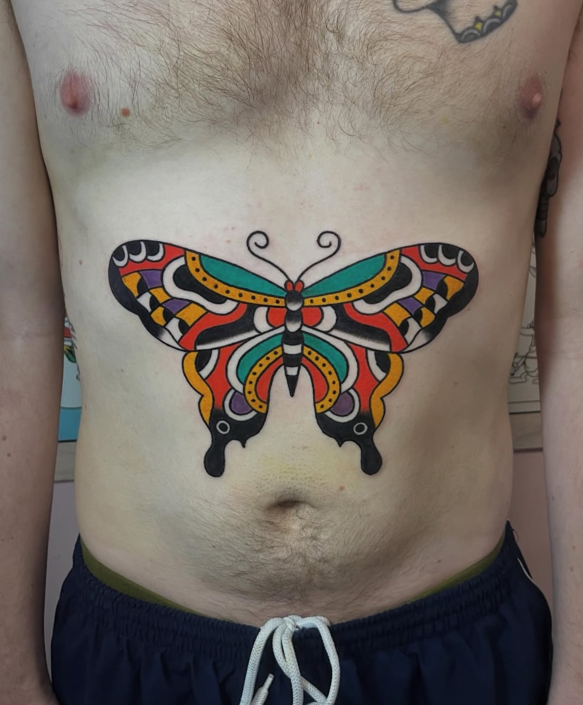 Butterfly geometric tattoo on the ribs by Traditional Tattooing
