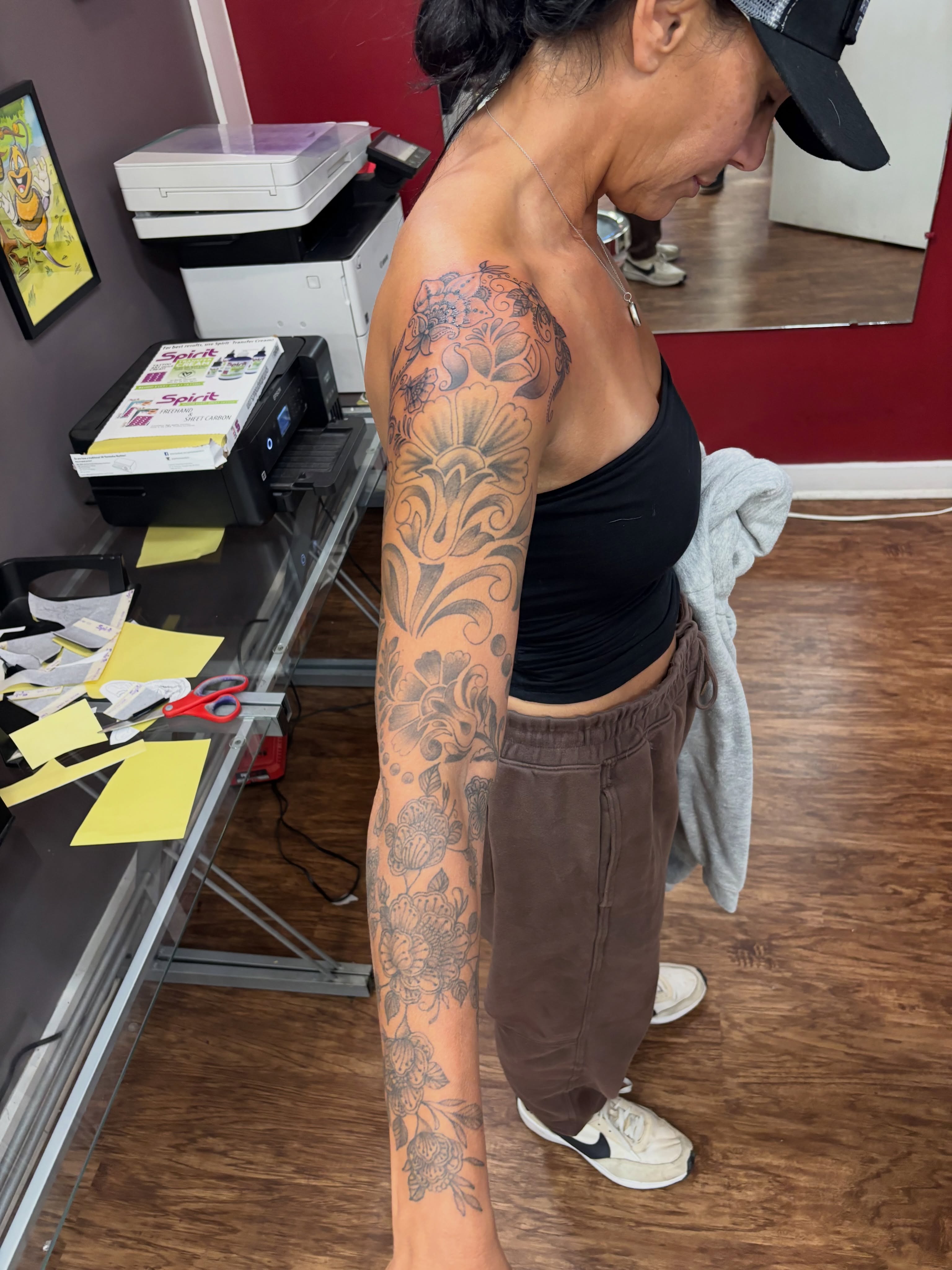 Floral black and grey tattoo on the upper arm by Thom Johns-Green