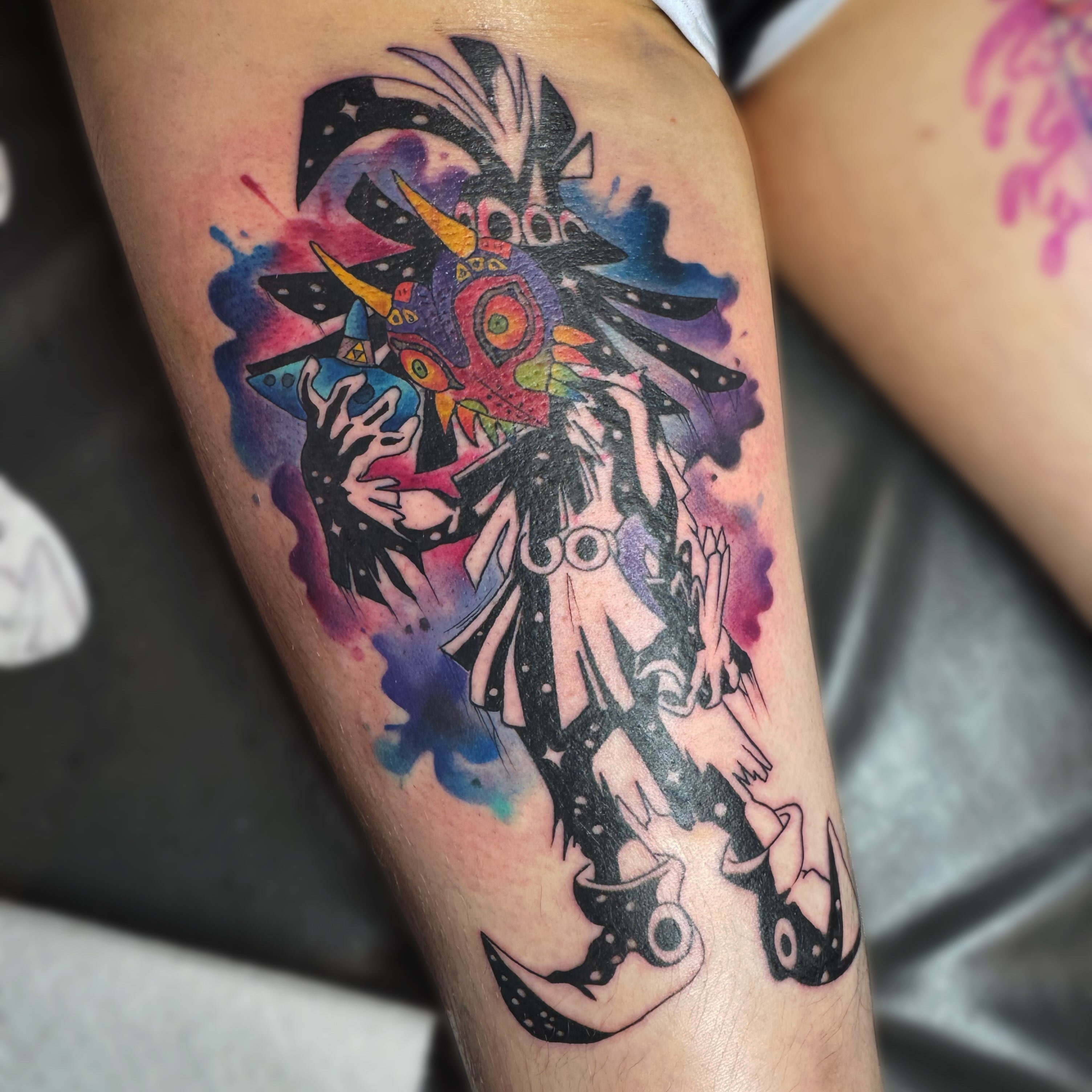 Mask and creature watercolor tattoo on the forearm by Kelsey 🖤 Tattoo Artist, Waterford Township