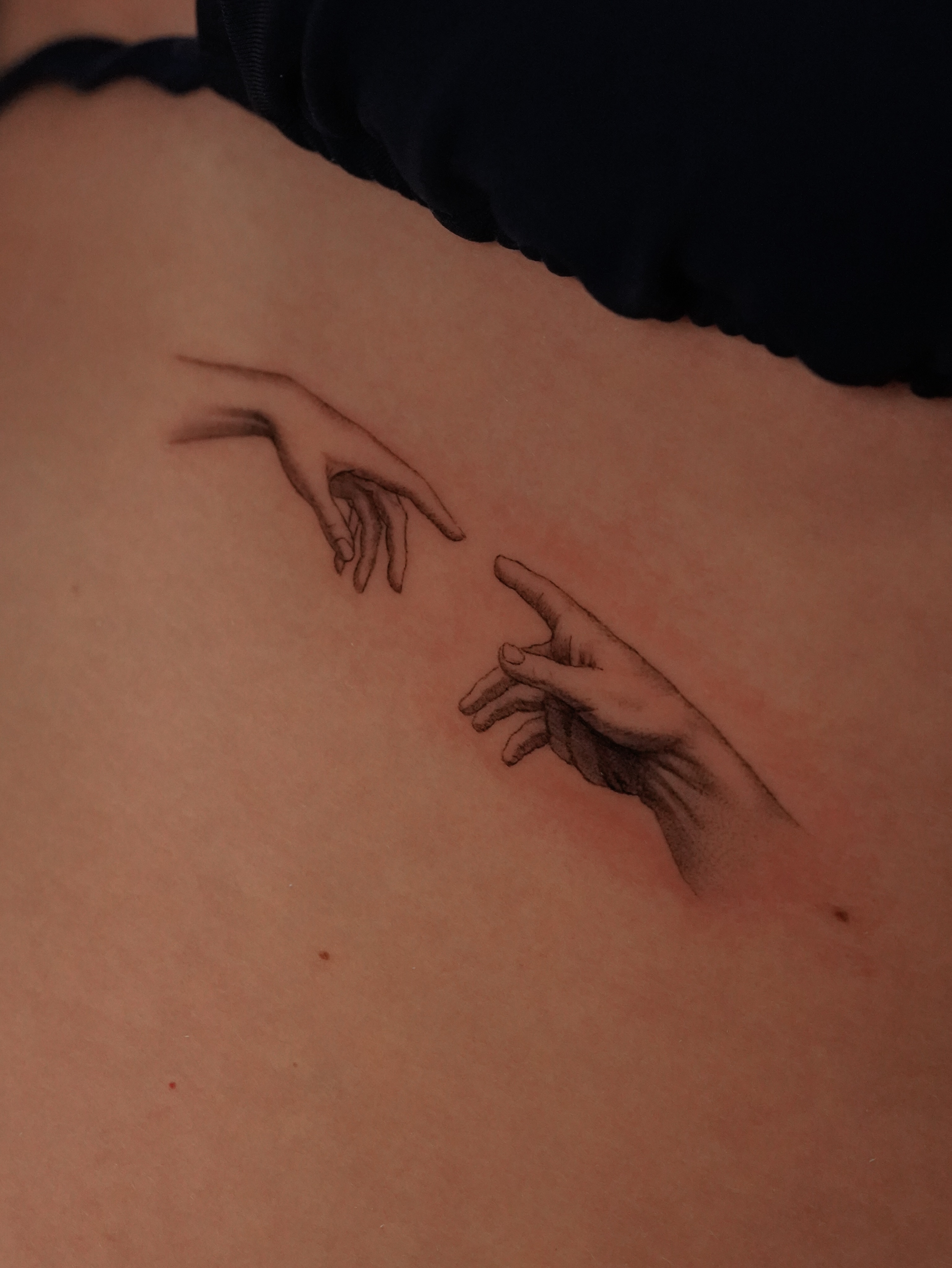 Hands reaching black and grey tattoo on the back by eddie chavez