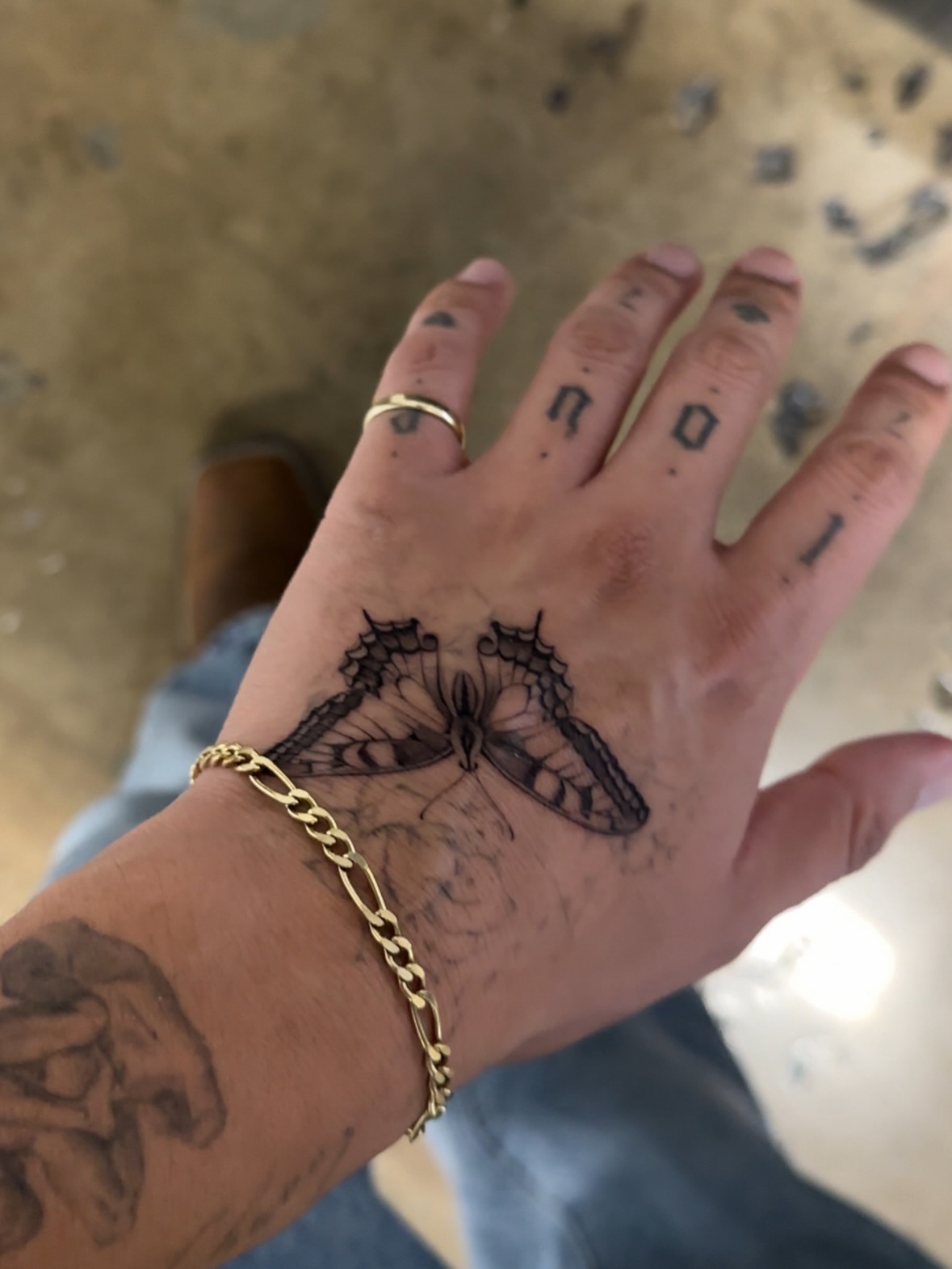 Butterfly black and grey tattoo on the hand by eddie chavez