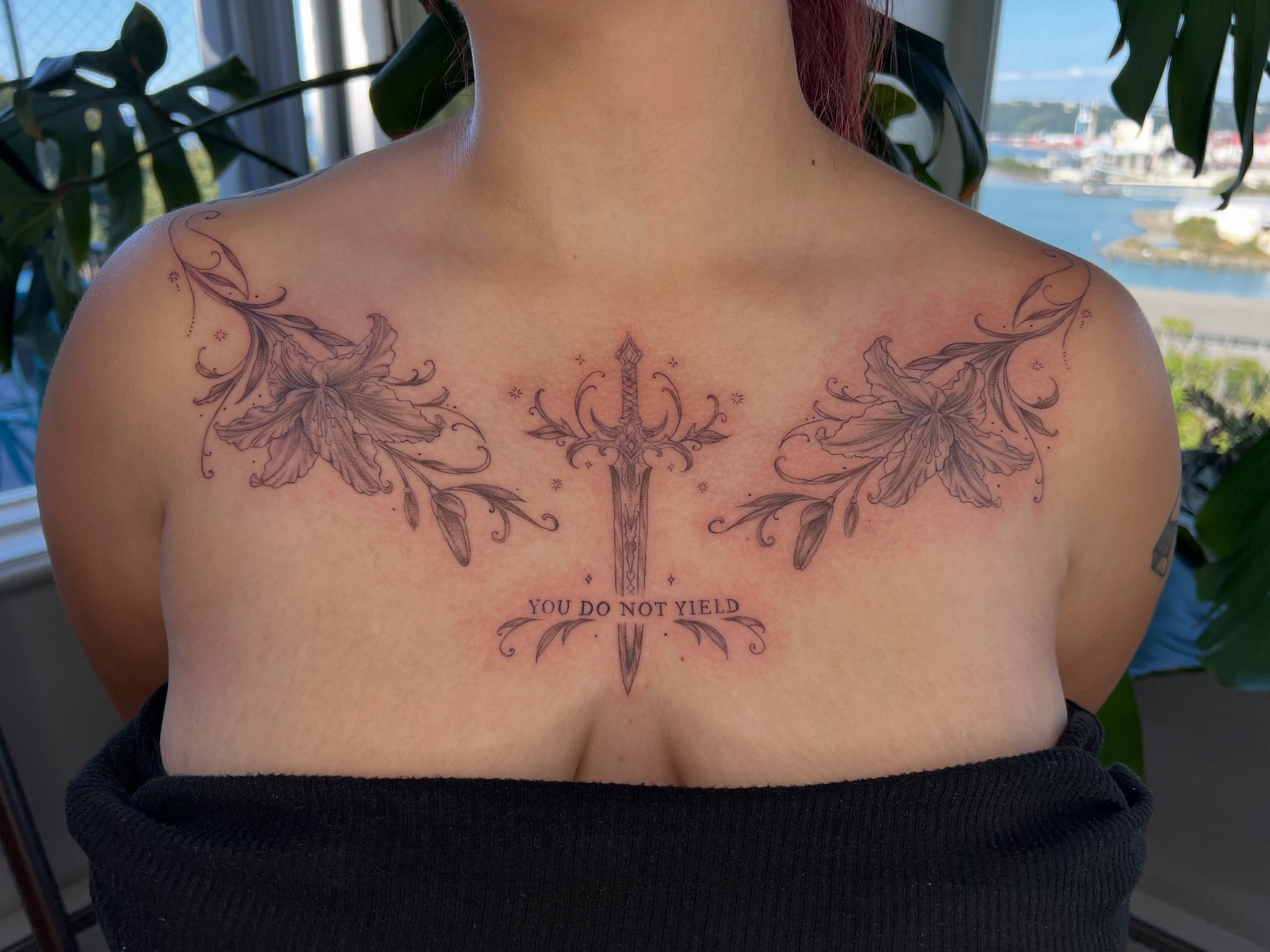 Sword and floral ornamental tattoo on the chest by Jordi WA Tacoma Tattooer