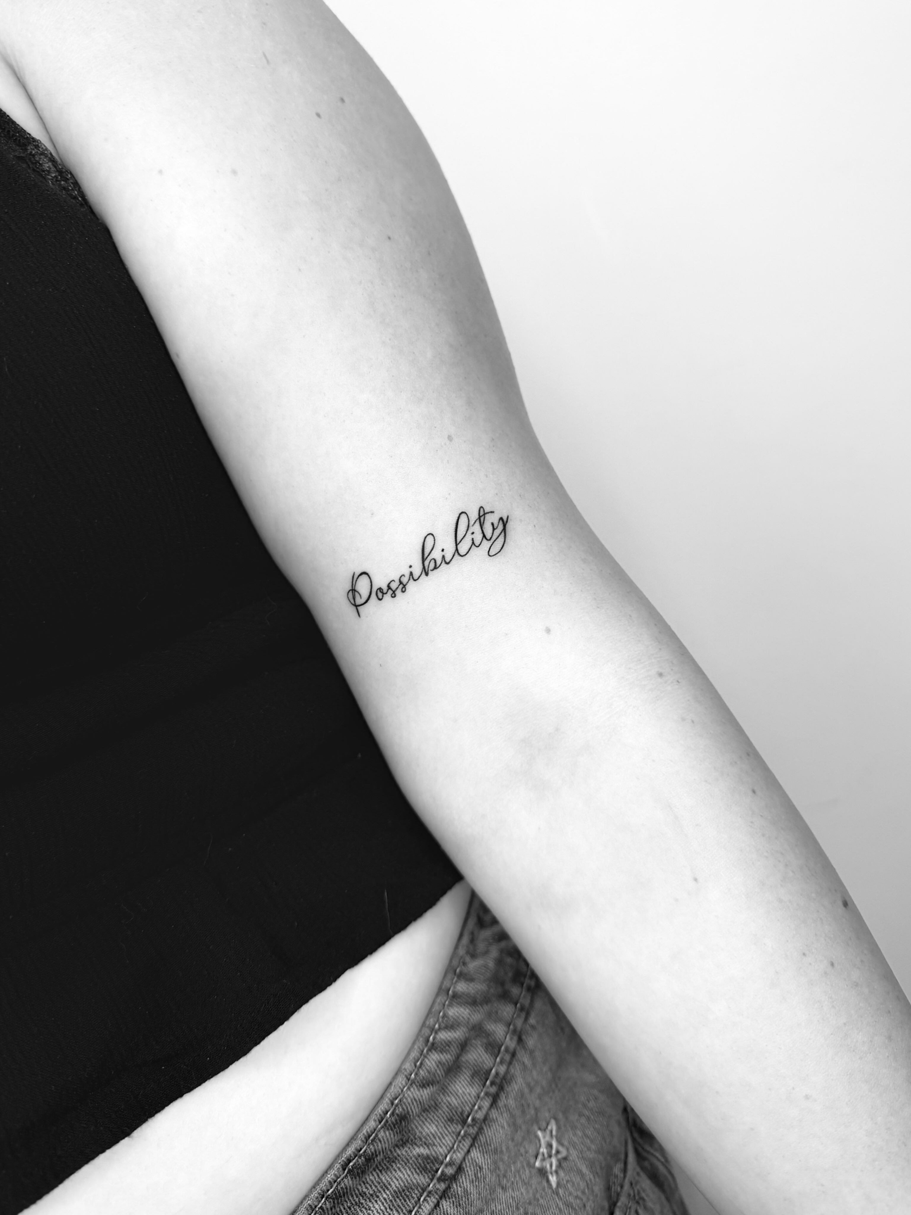 Possibility lettering script tattoo on the forearm by Fine Line Tattoo Artist