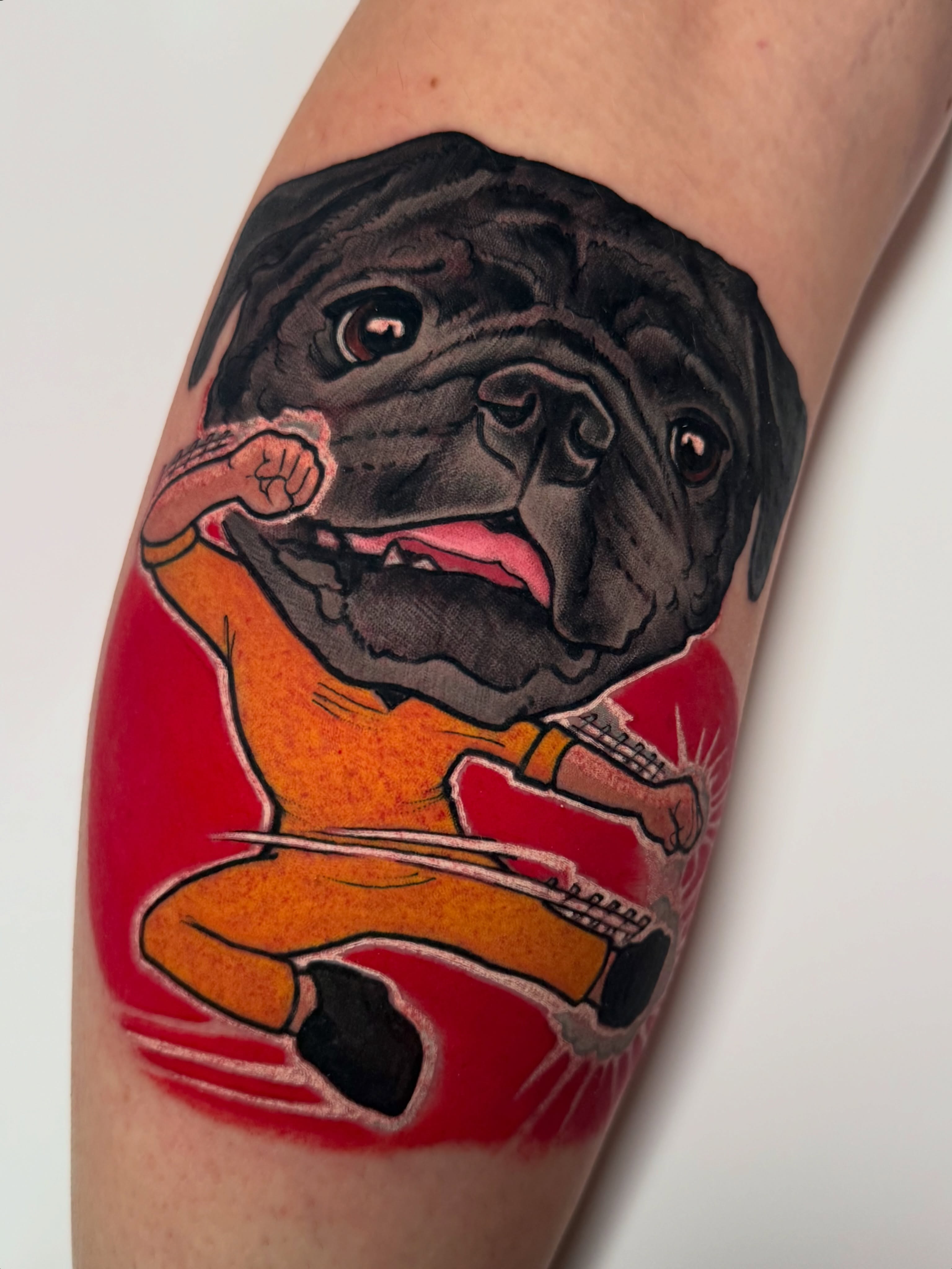 Pug playing guitar realism tattoo on the forearm by Missi Blue