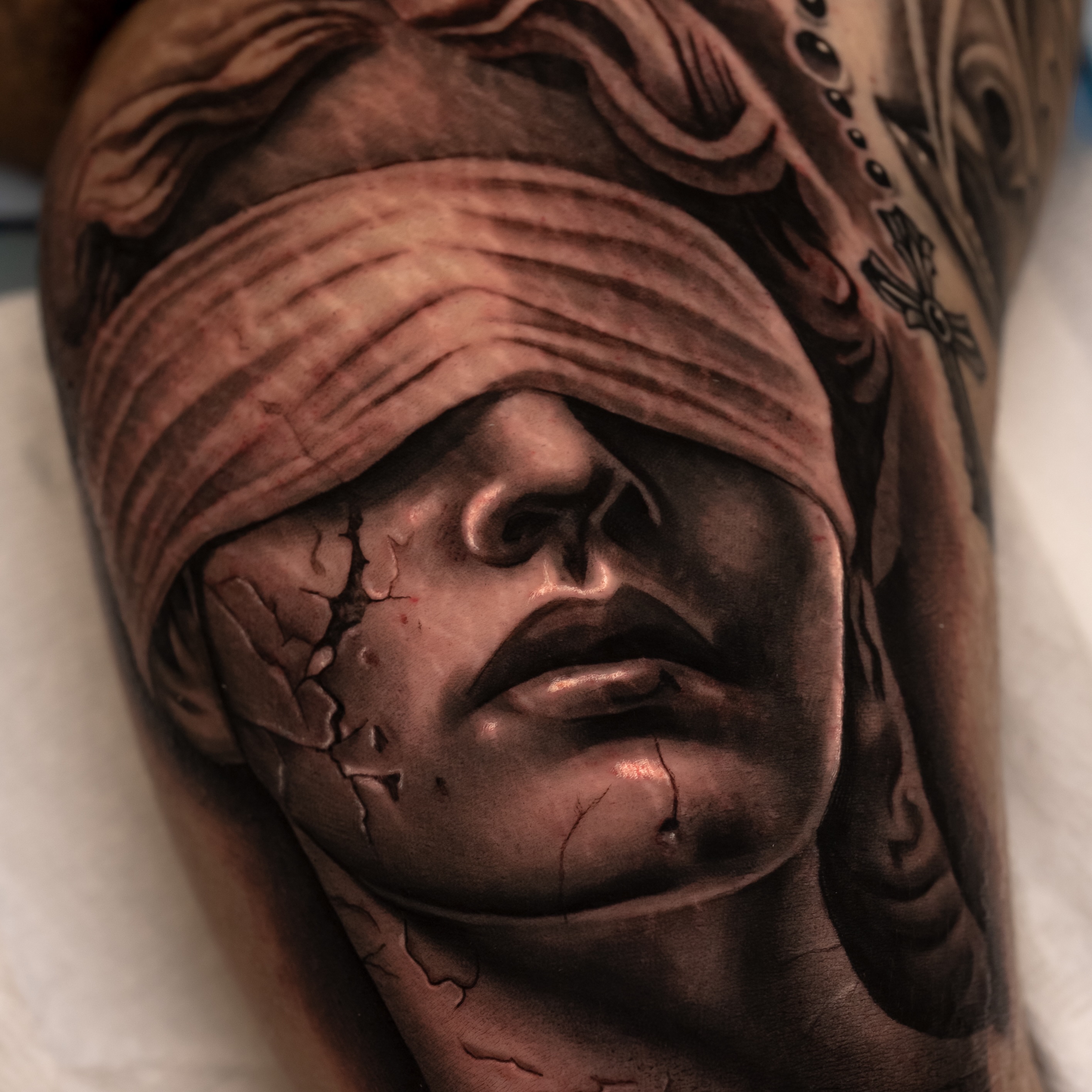 Blindfolded man realism tattoo on the forearm by Javier Chavez