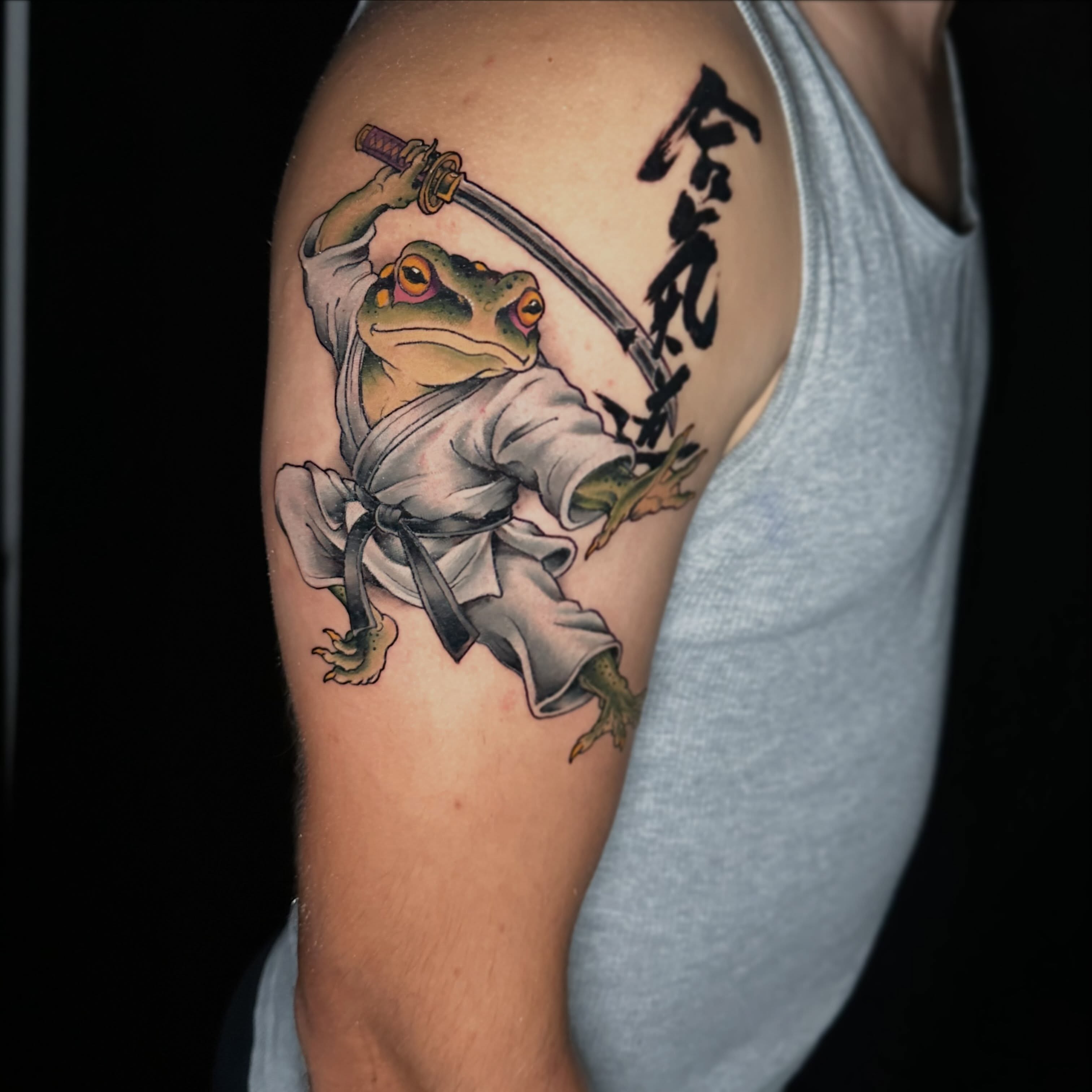 Frog in karate pose realism tattoo on the forearm by John Milosh Chamberlin