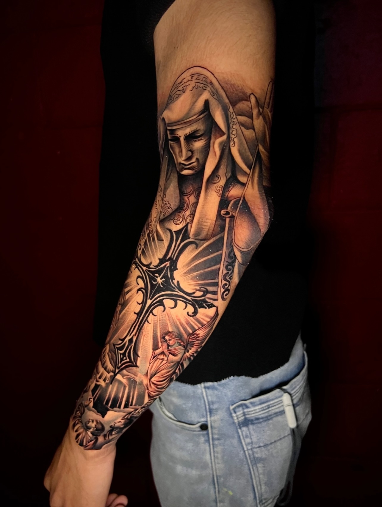 Religious figure realism tattoo on the forearm by El Salvador Tattoo Artist