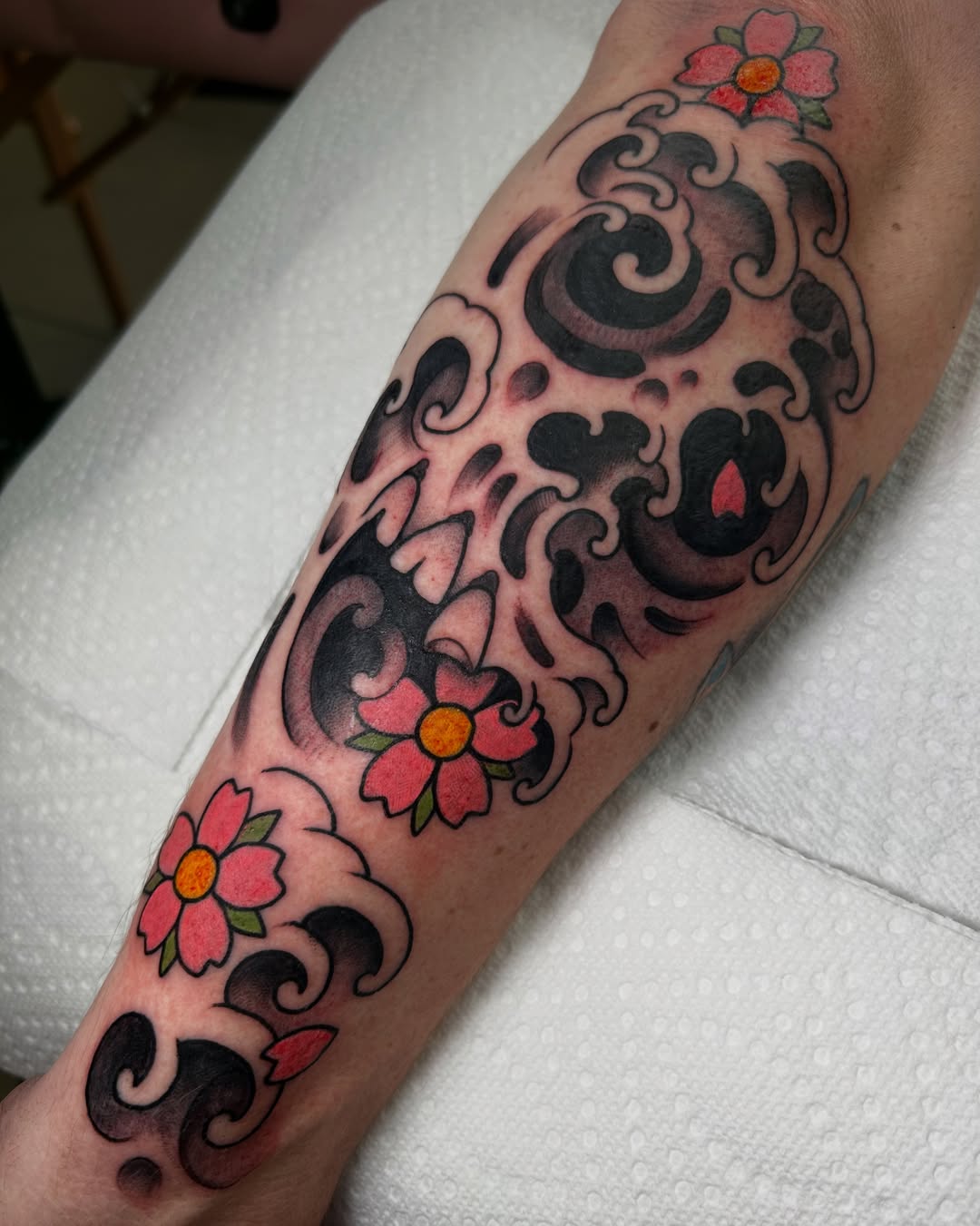 Floral swirls American traditional tattoo on the forearm by Katie Dexter, Des Moines, Iowa