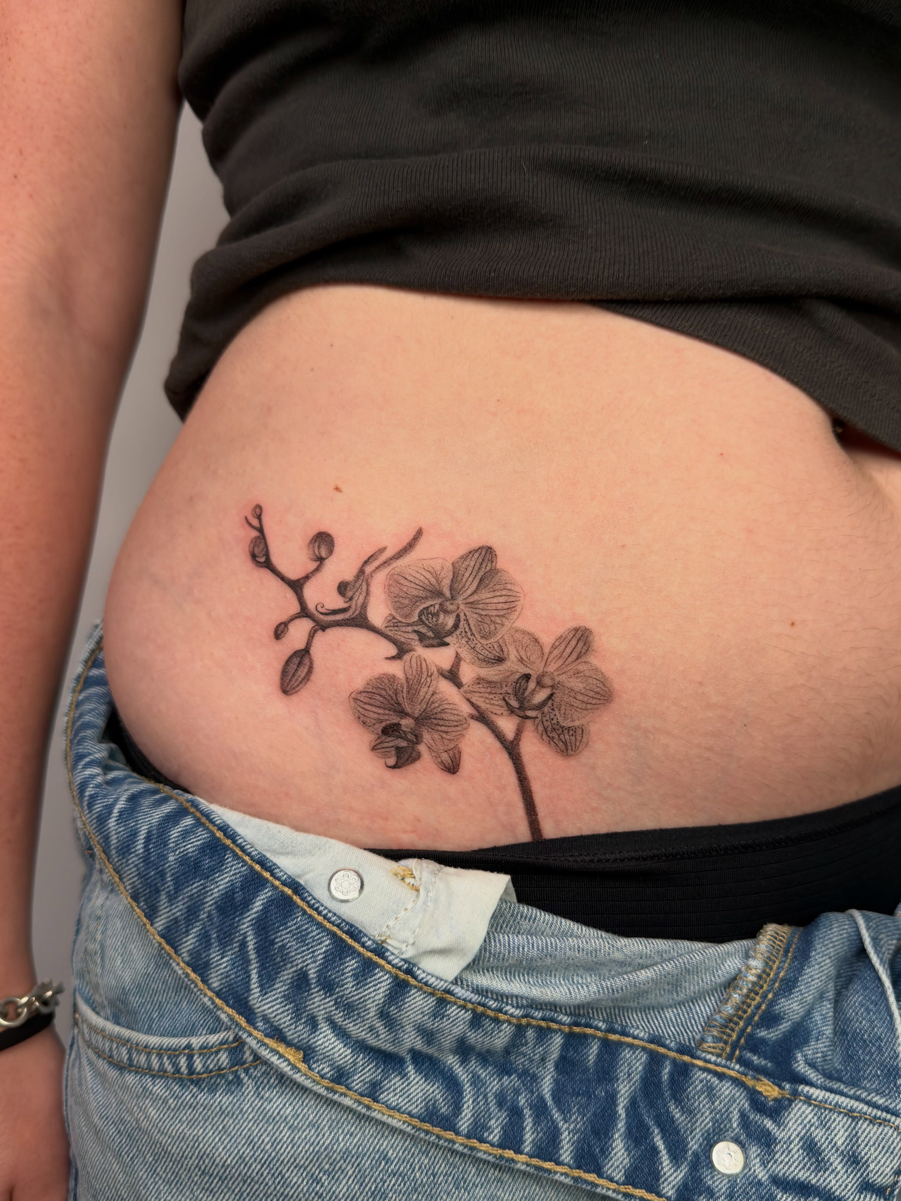 Orchid black and grey tattoo on the ribs by Nayoung, San Francisco, California