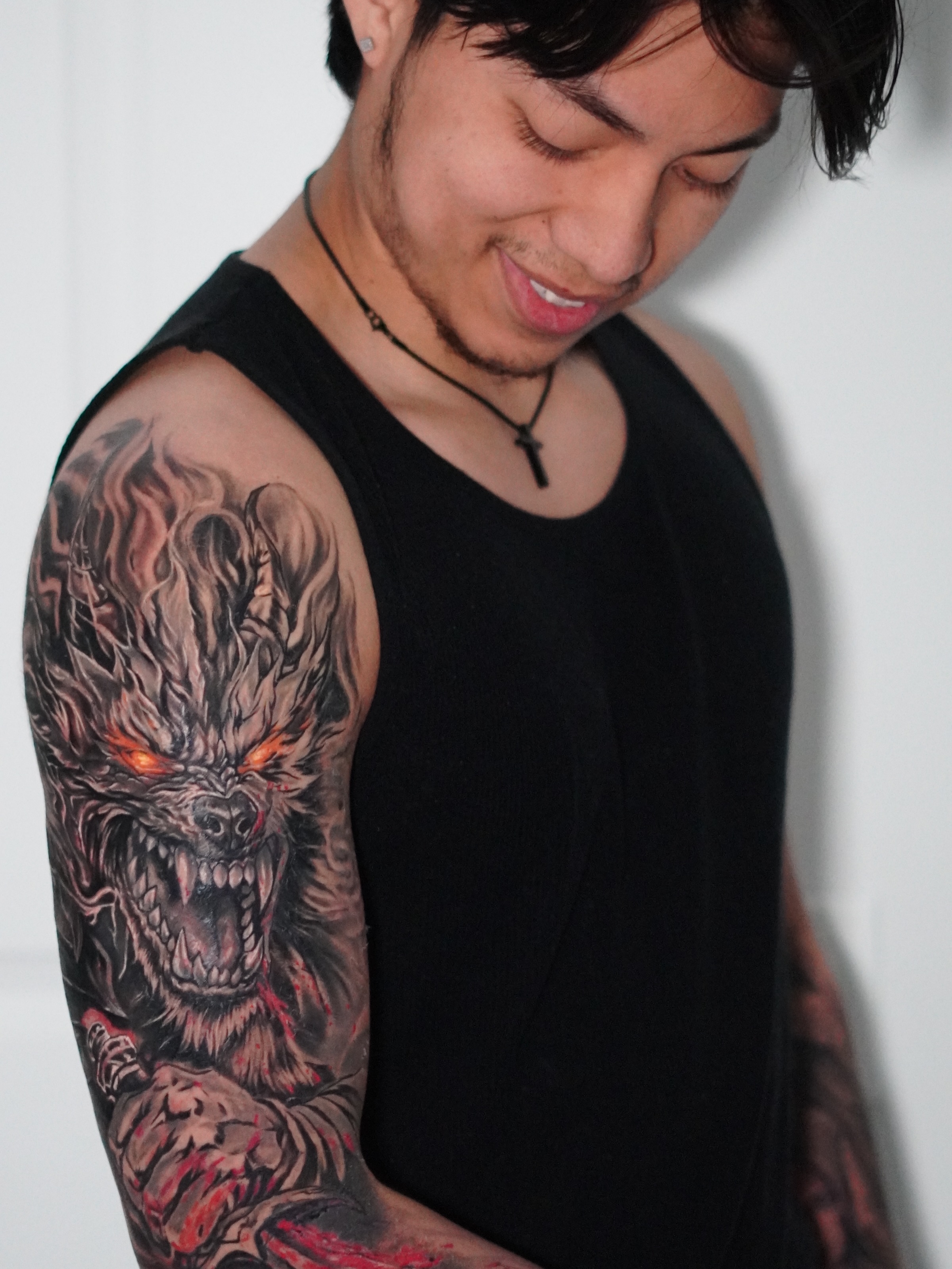 Demon dark realism tattoo on the upper arm by Angel Gonzalez