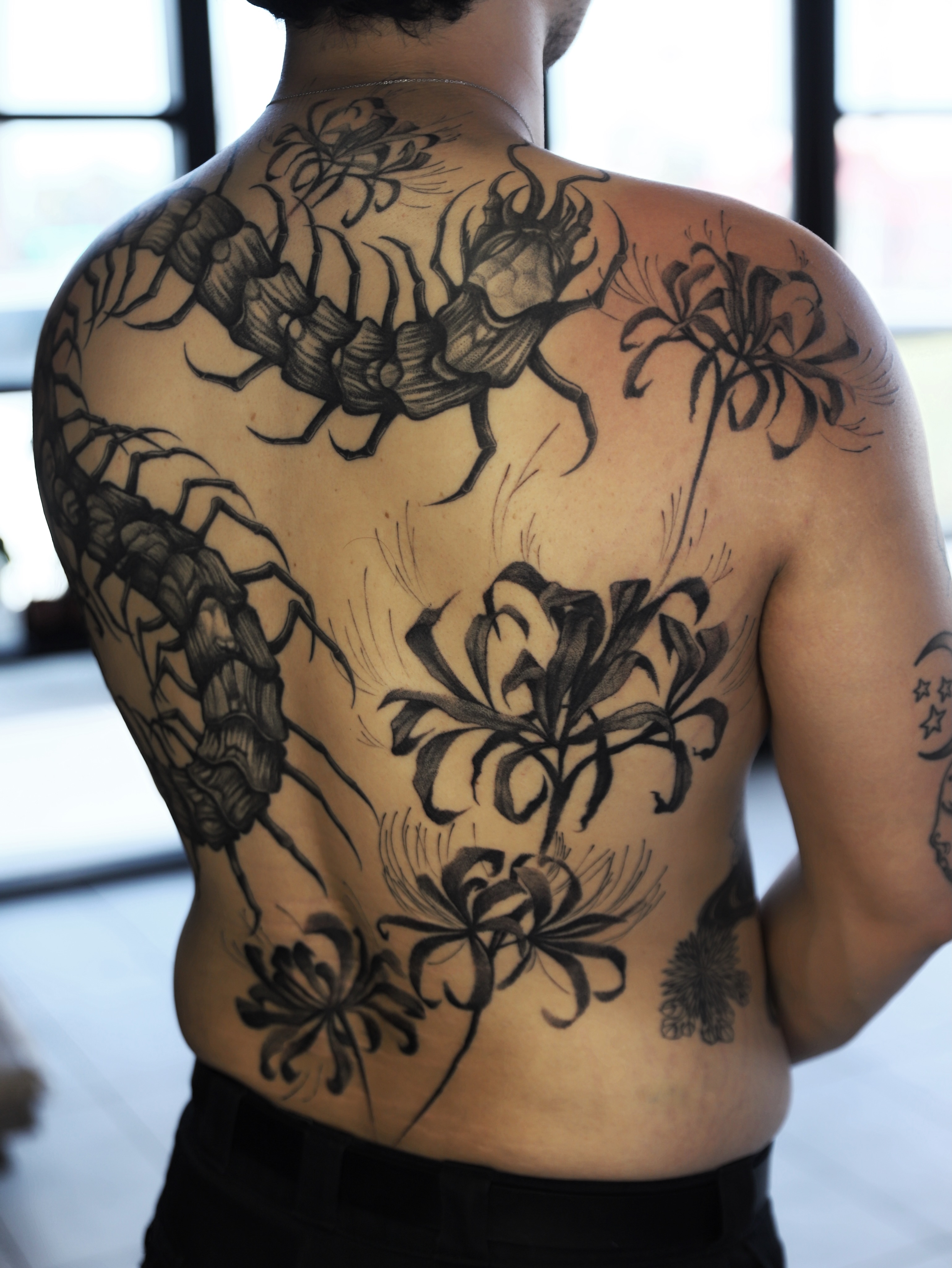 Scorpions and flowers black and grey tattoo on the back by Las Vegas tattoo