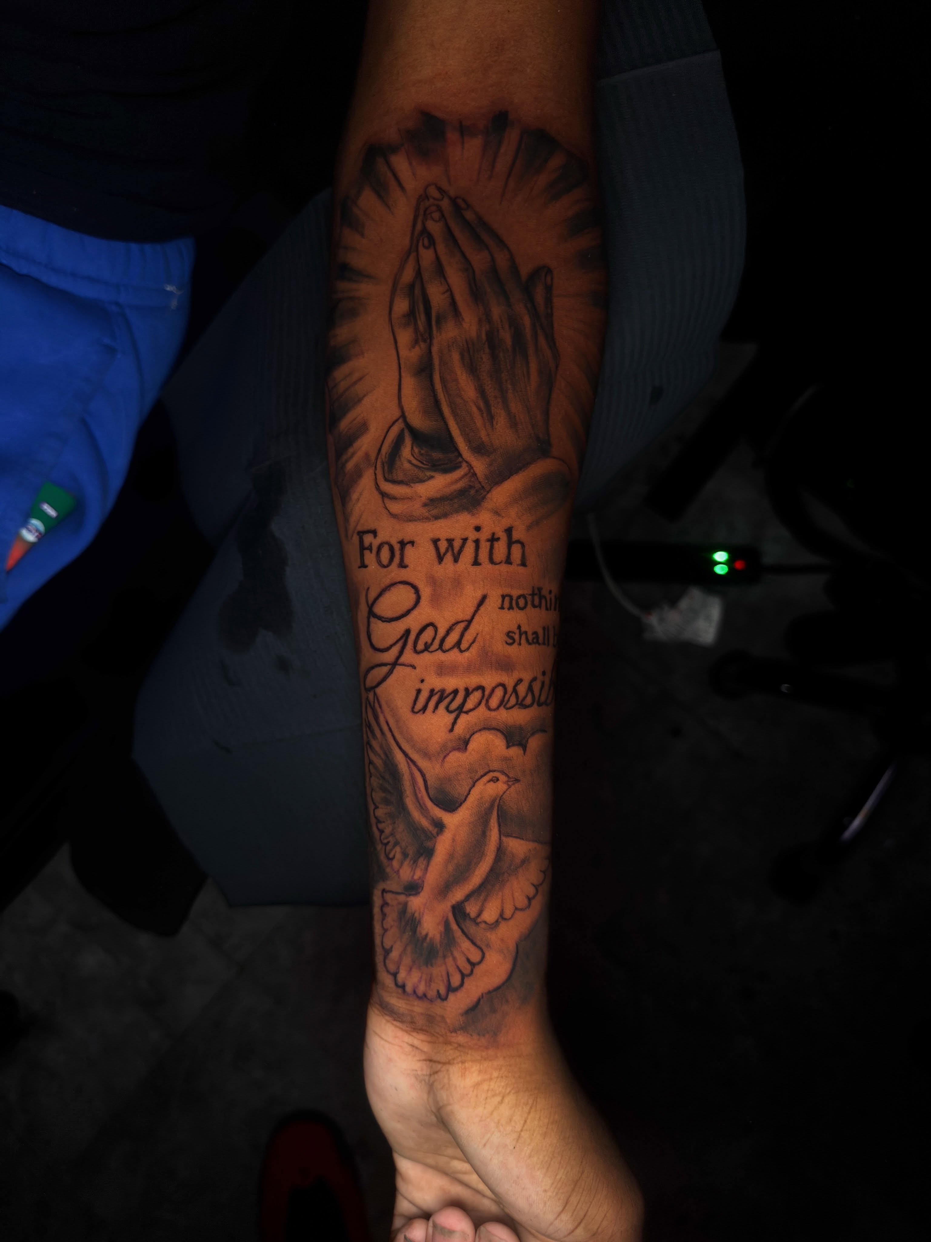 Praying hands and dove black and grey tattoo on the forearm by dallas tattoo artist, Duncanville, Texas