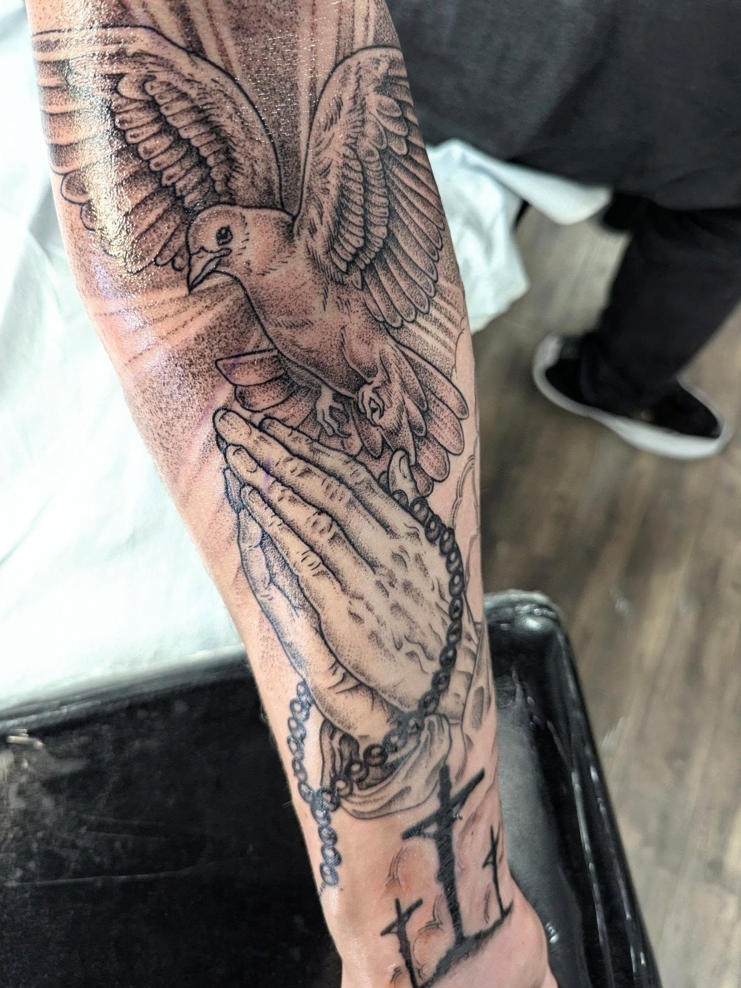 Praying hands with dove dotwork tattoo on the forearm by DONEL 📍Denver