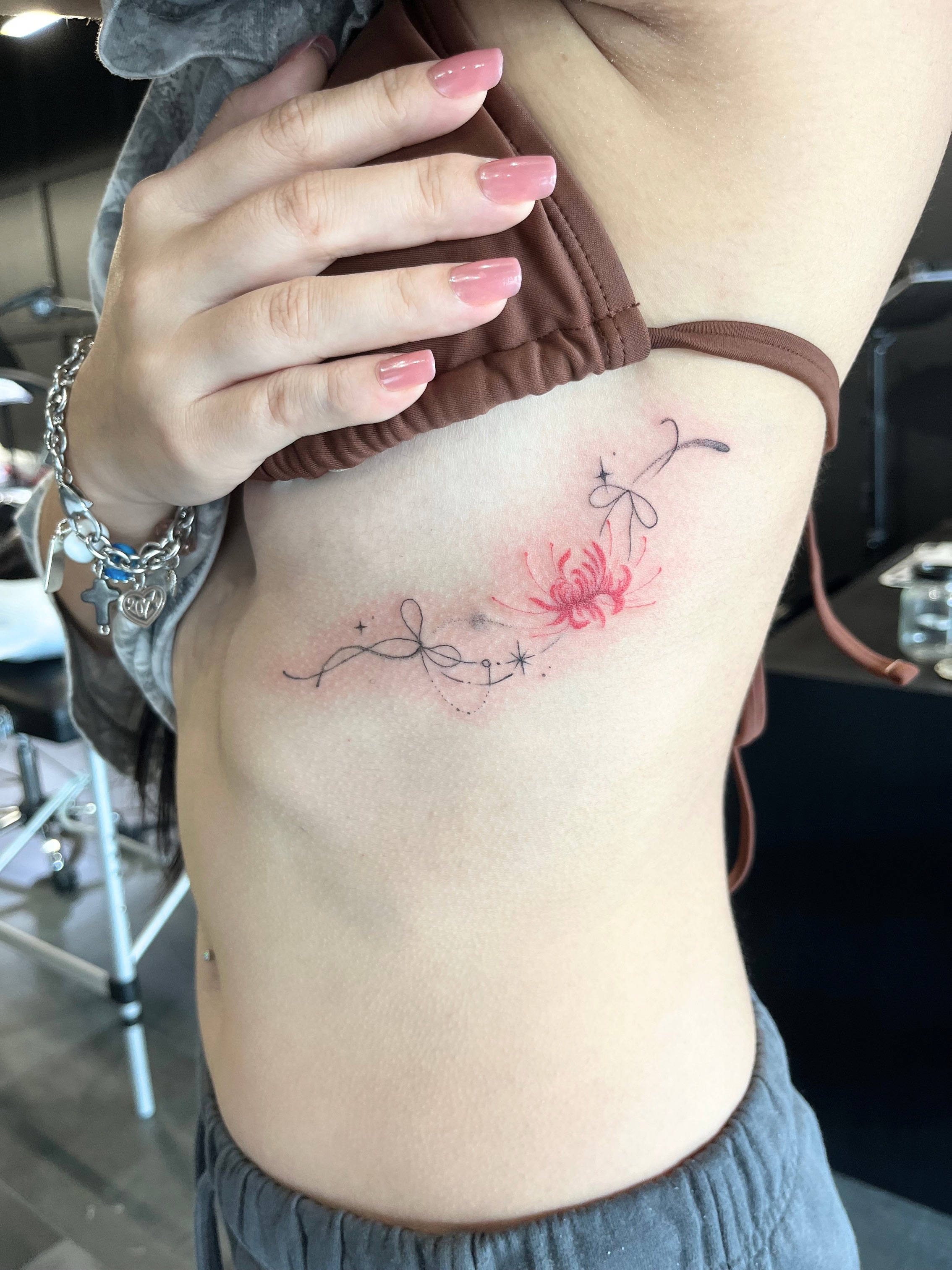 Flower and abstract design dotwork tattoo on the ribs by kt