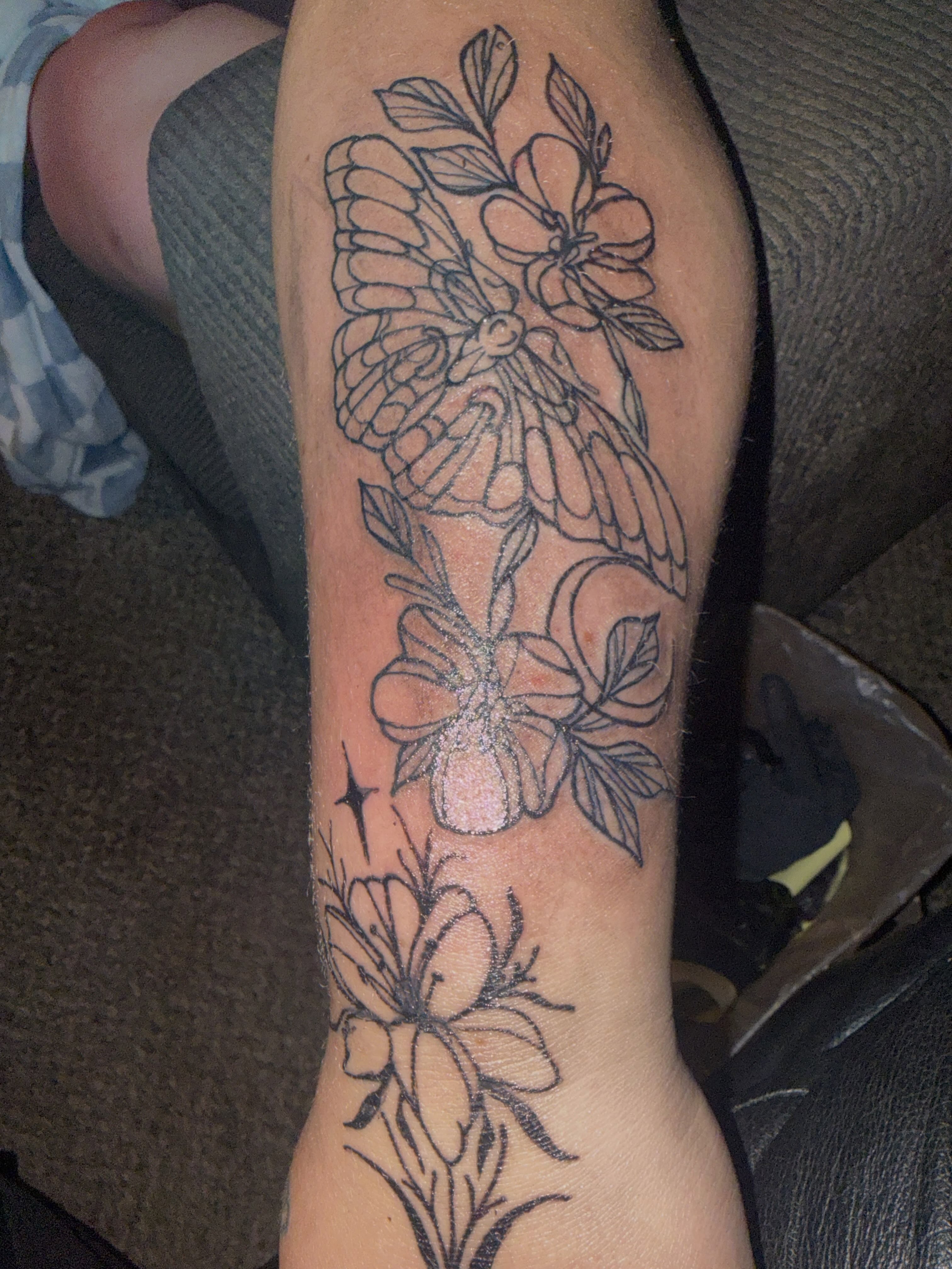 Butterfly and flowers black and grey tattoo on the forearm by Tatz By Benji