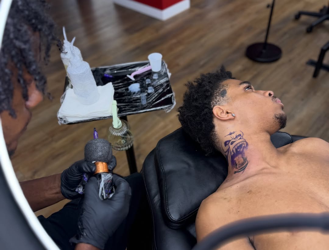 Angry face neo-traditional tattoo on the neck by Art Plug