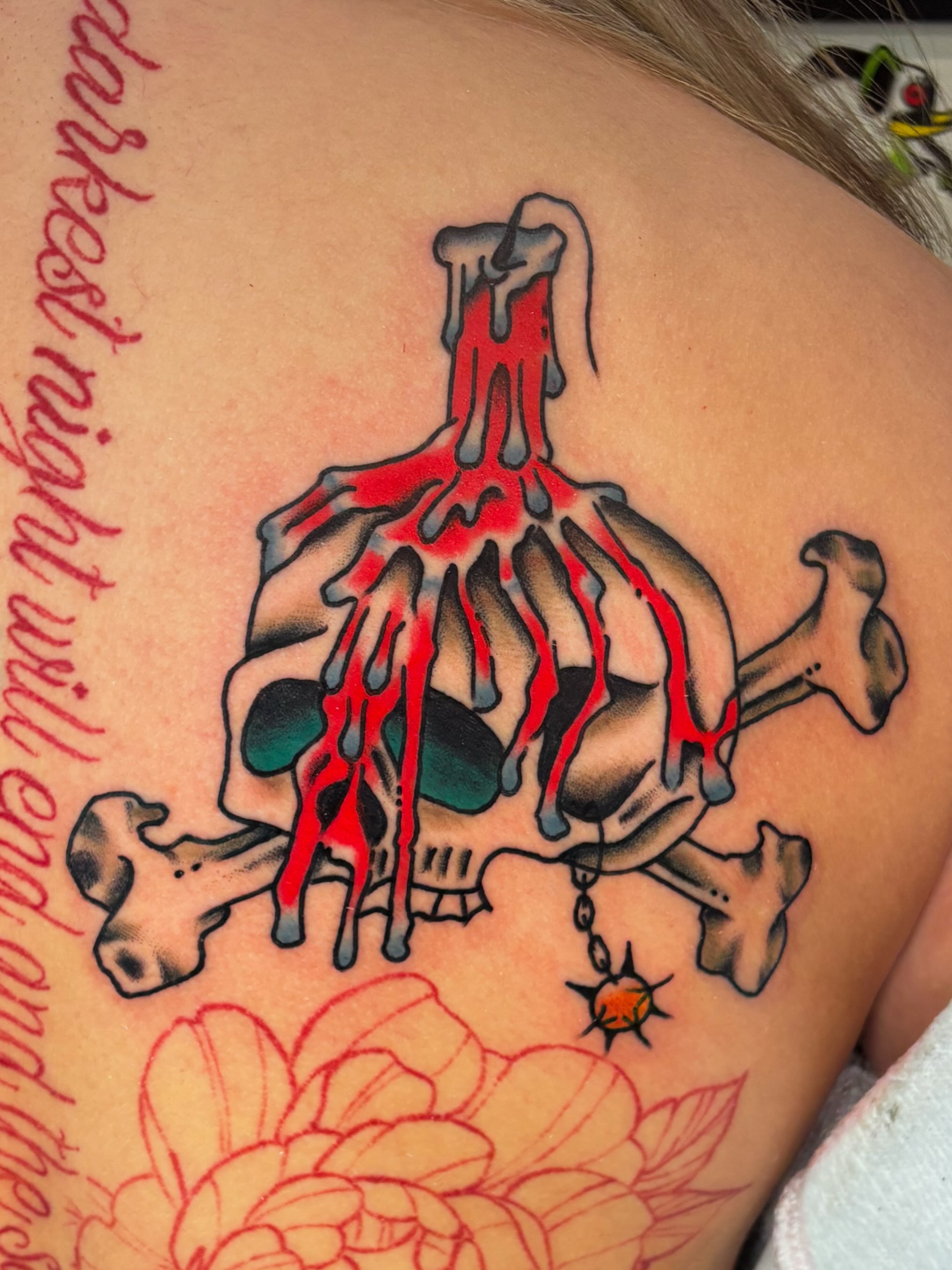 Skull and crossbones with dripping blood American traditional tattoo on the shoulder by Evan Bisso, Philadelphia, Pennsylvania