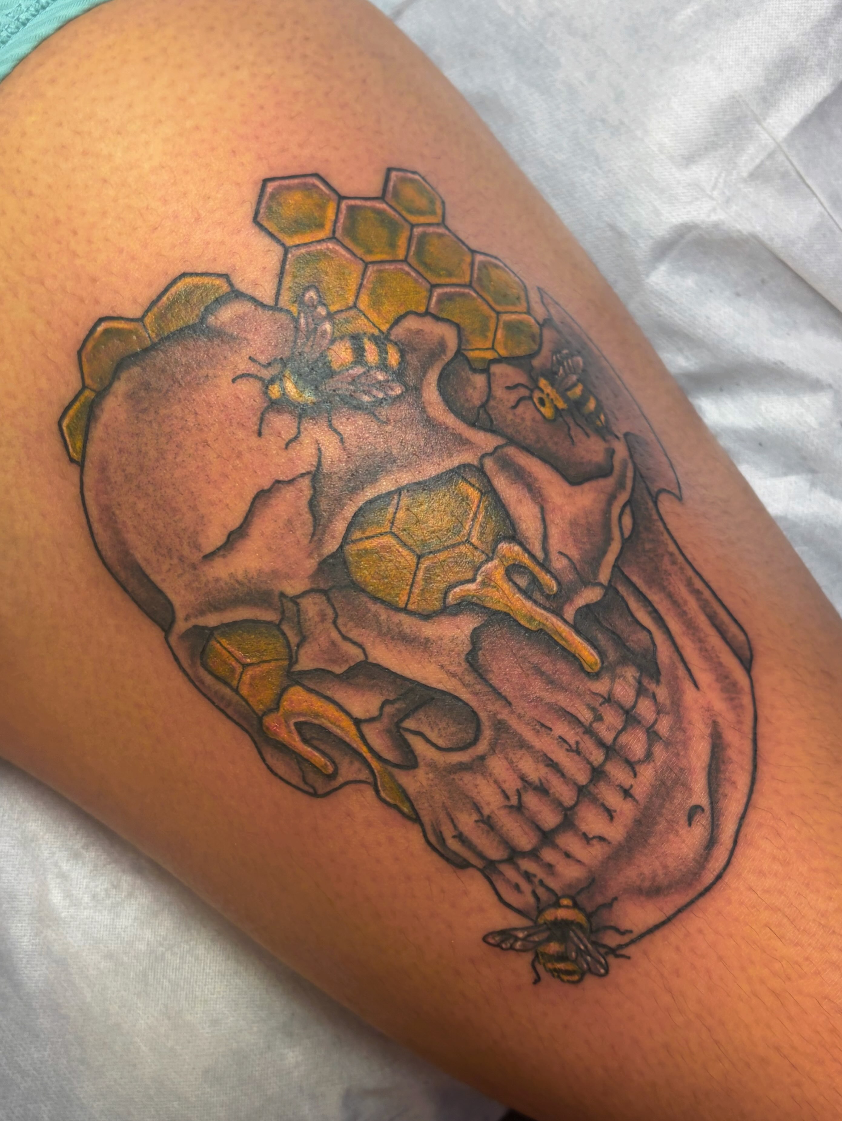 Skull with honeycomb geometric tattoo on the thigh by Mary Hannah Sosdian