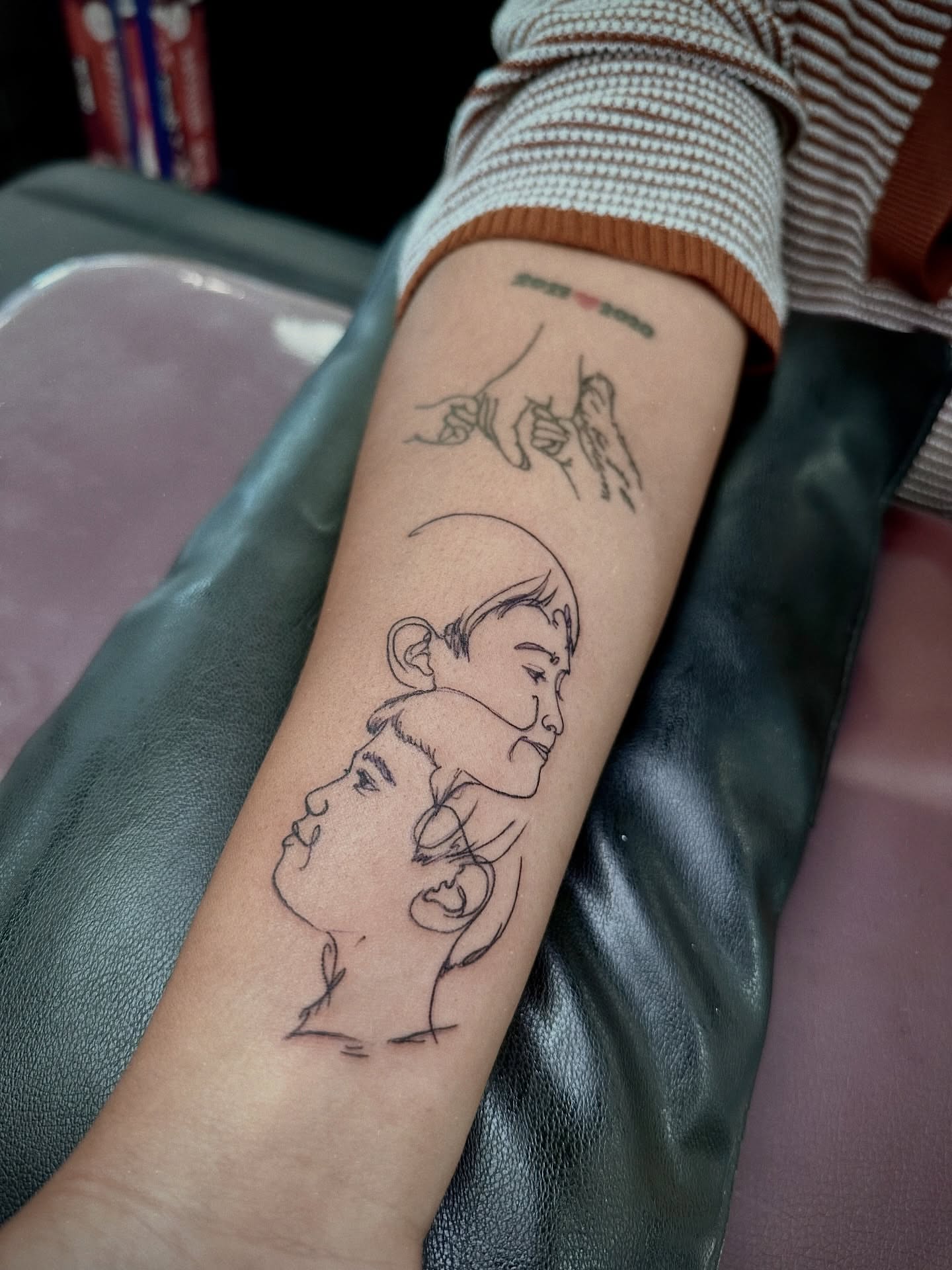 Mother and child fine line tattoo on the forearm by Marlyn “Lala”