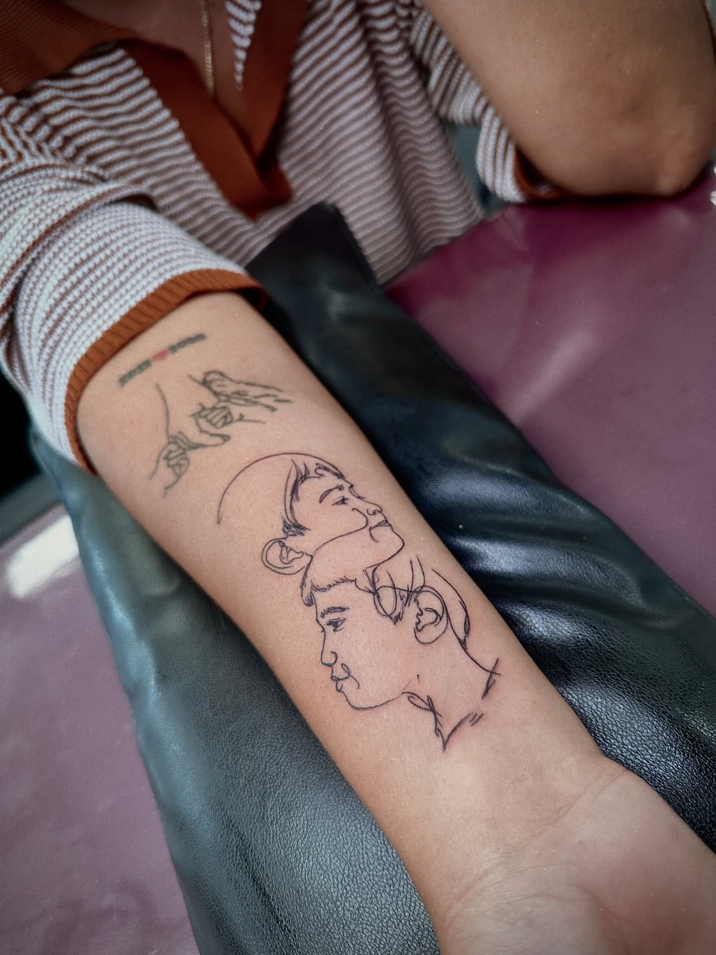 Profile faces minimalist tattoo on the forearm by Marlyn “Lala”