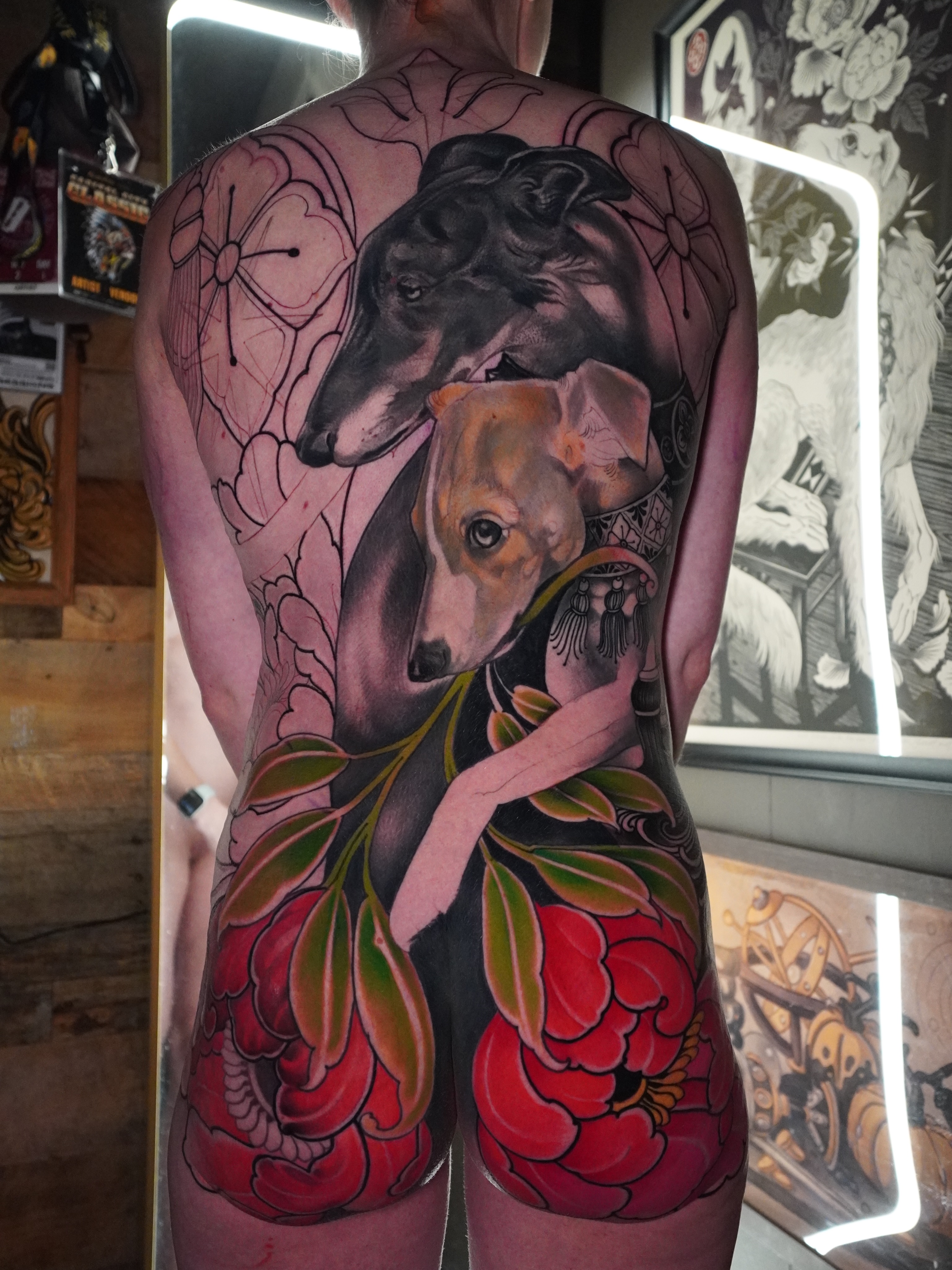 Greyhounds and flowers American traditional tattoo on the back by Lorena Borges Gomes