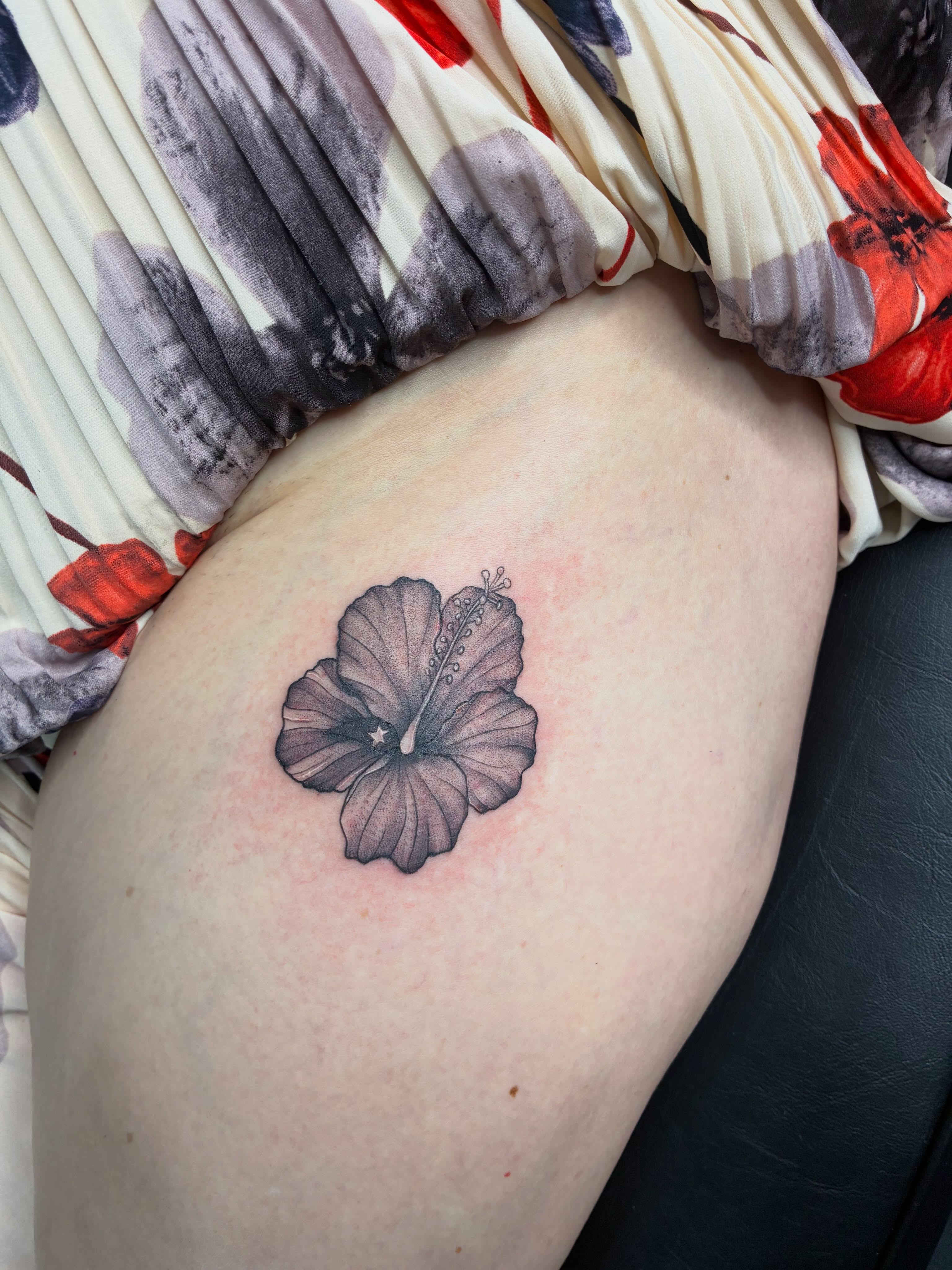Hibiscus flower black and grey tattoo on the thigh by Tattoos by Hailey