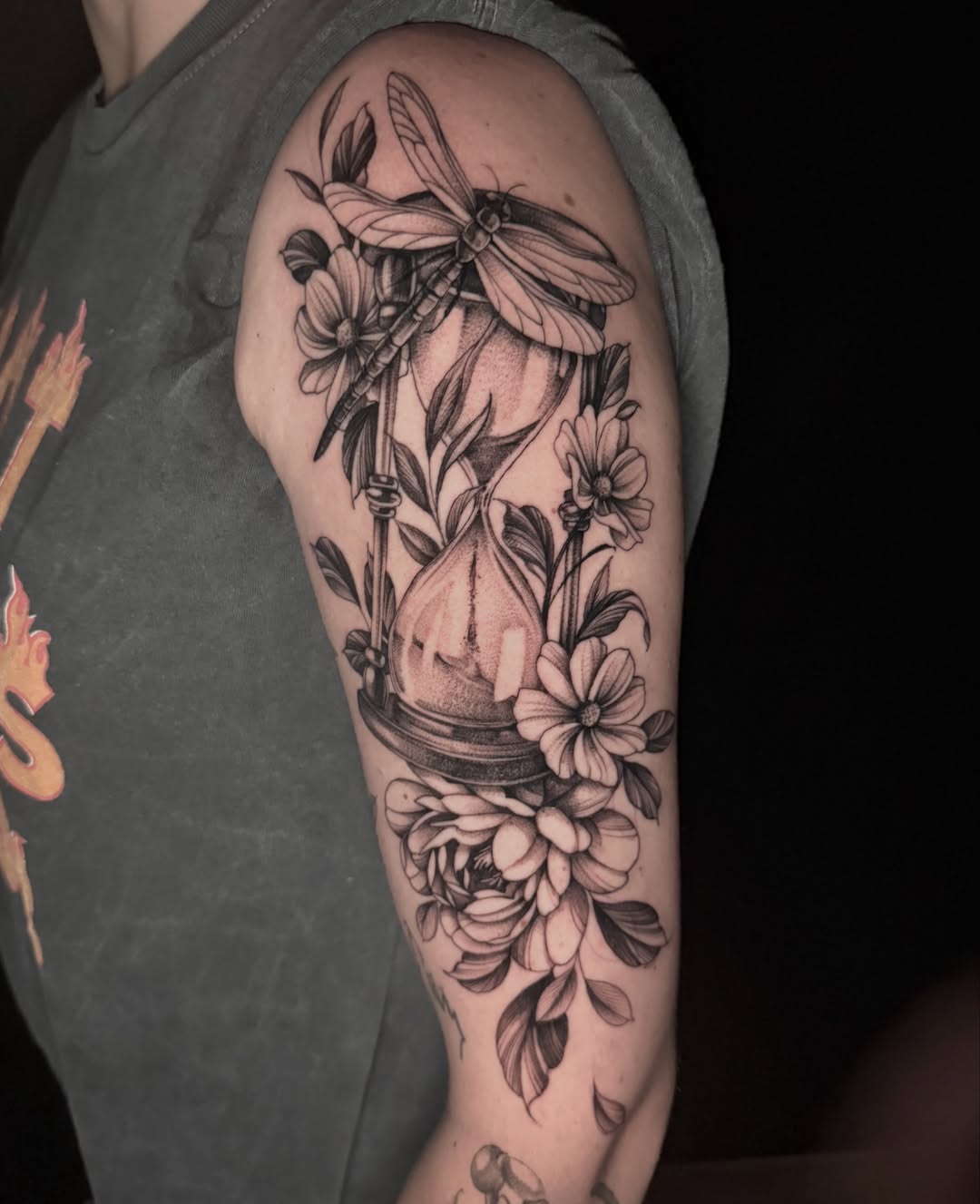 Dragonfly and floral arrangement realism tattoo on the forearm by Chelsea Speirs