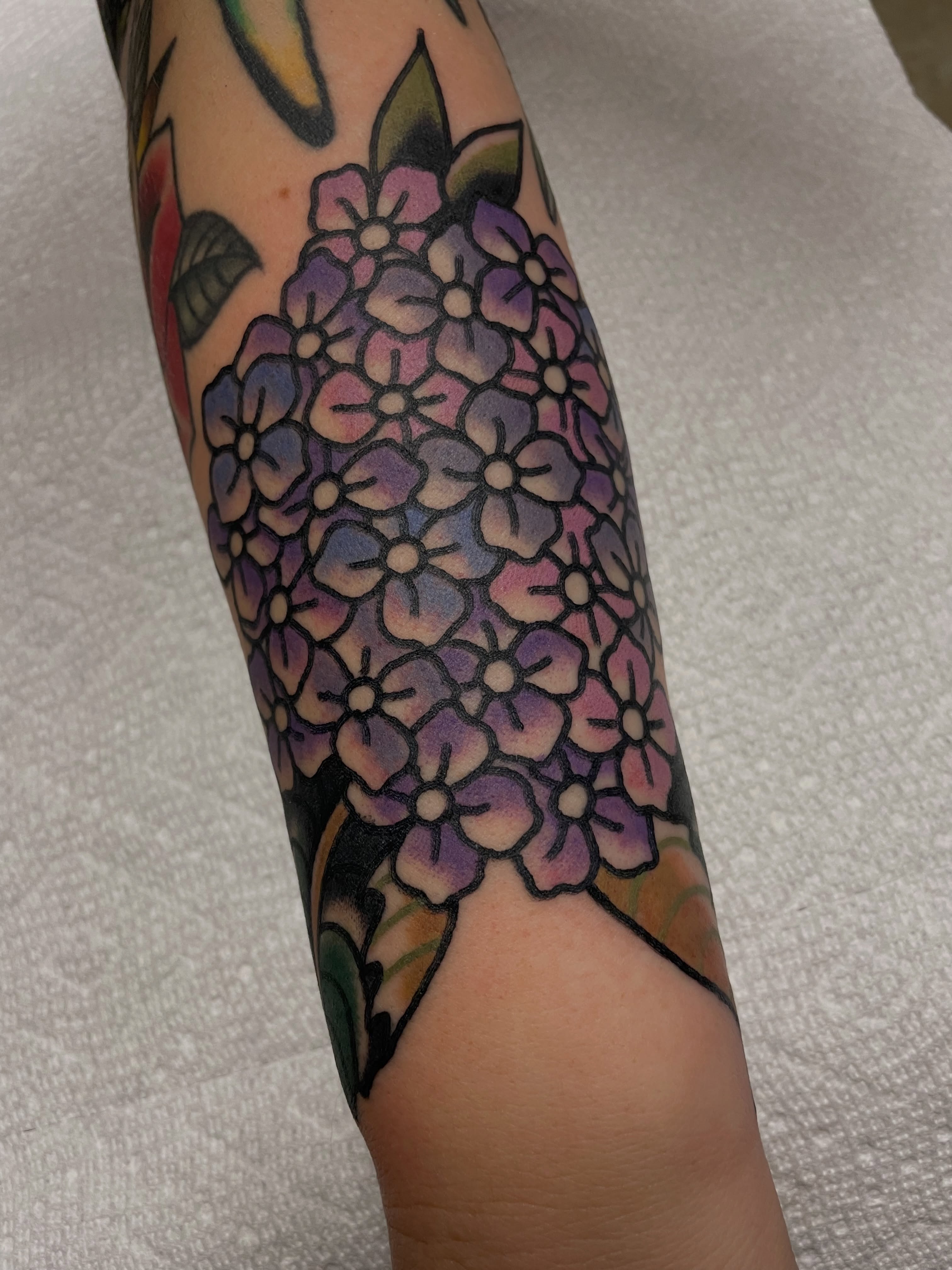 Hydrangea bouquet new school tattoo on the forearm by @pizzabref