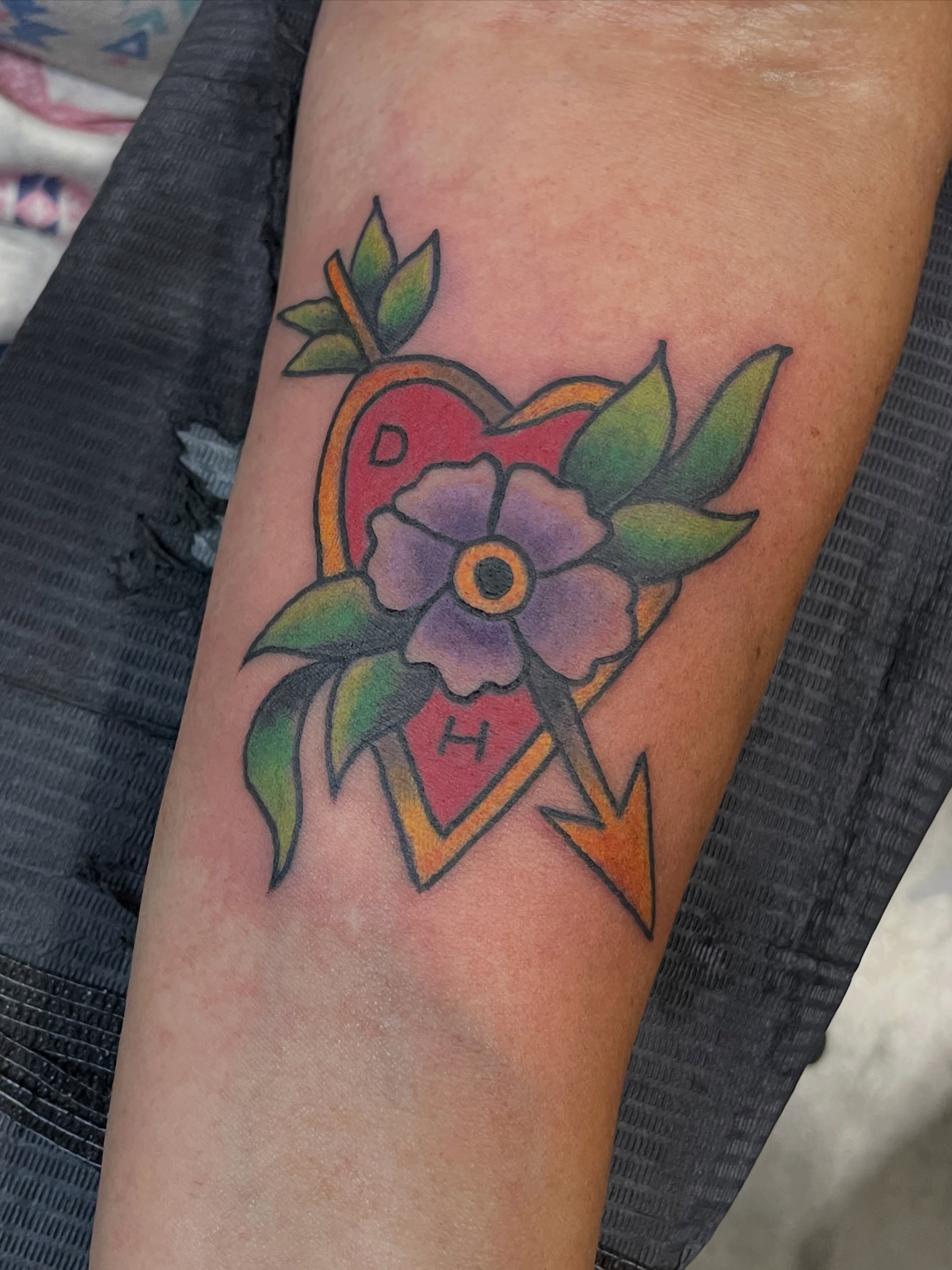 Flower and arrow American traditional tattoo on the forearm by Greg De Hoot, Youngsville, North Carolina