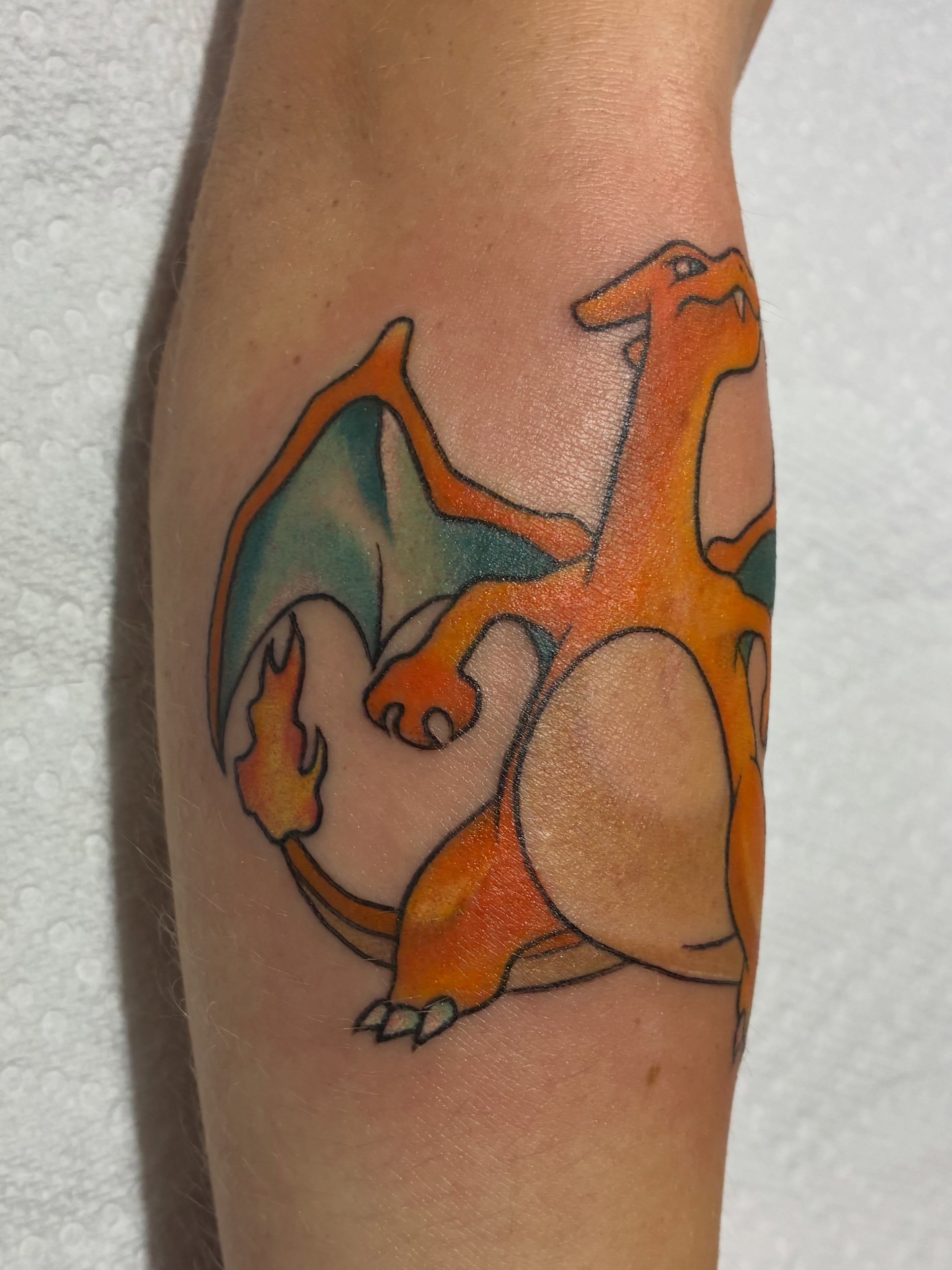 Charizard new school tattoo on the forearm by Natalie Spuhler