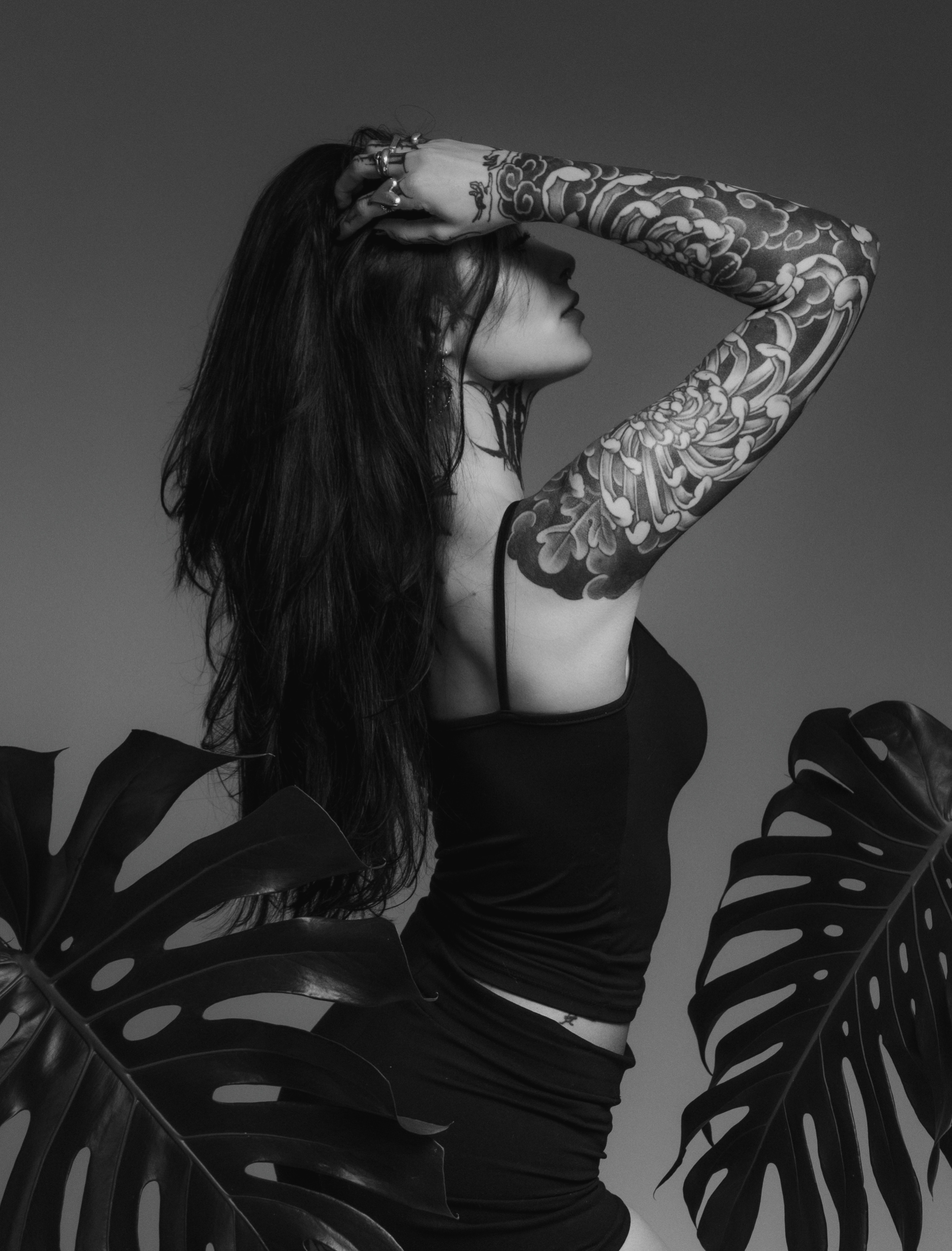 Floral pattern black and grey tattoo on the upper arm by Gabrieli Folha