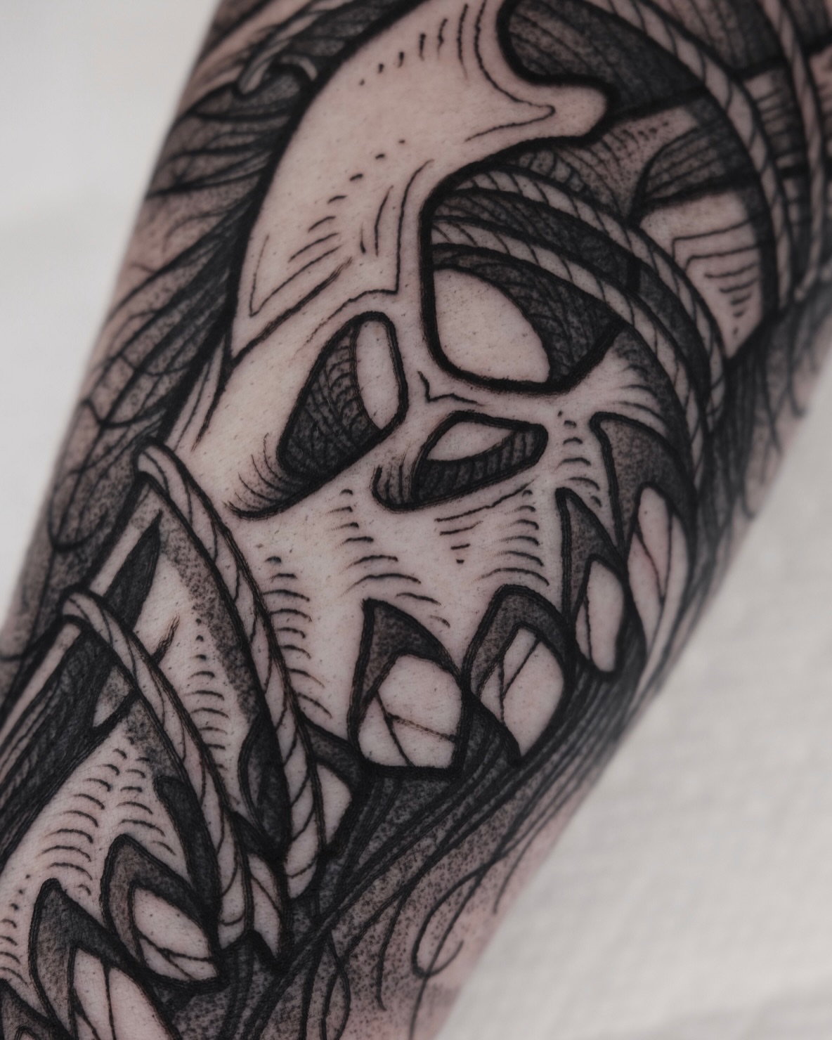 Grinning skull realism tattoo on the forearm by Kyle Patrick