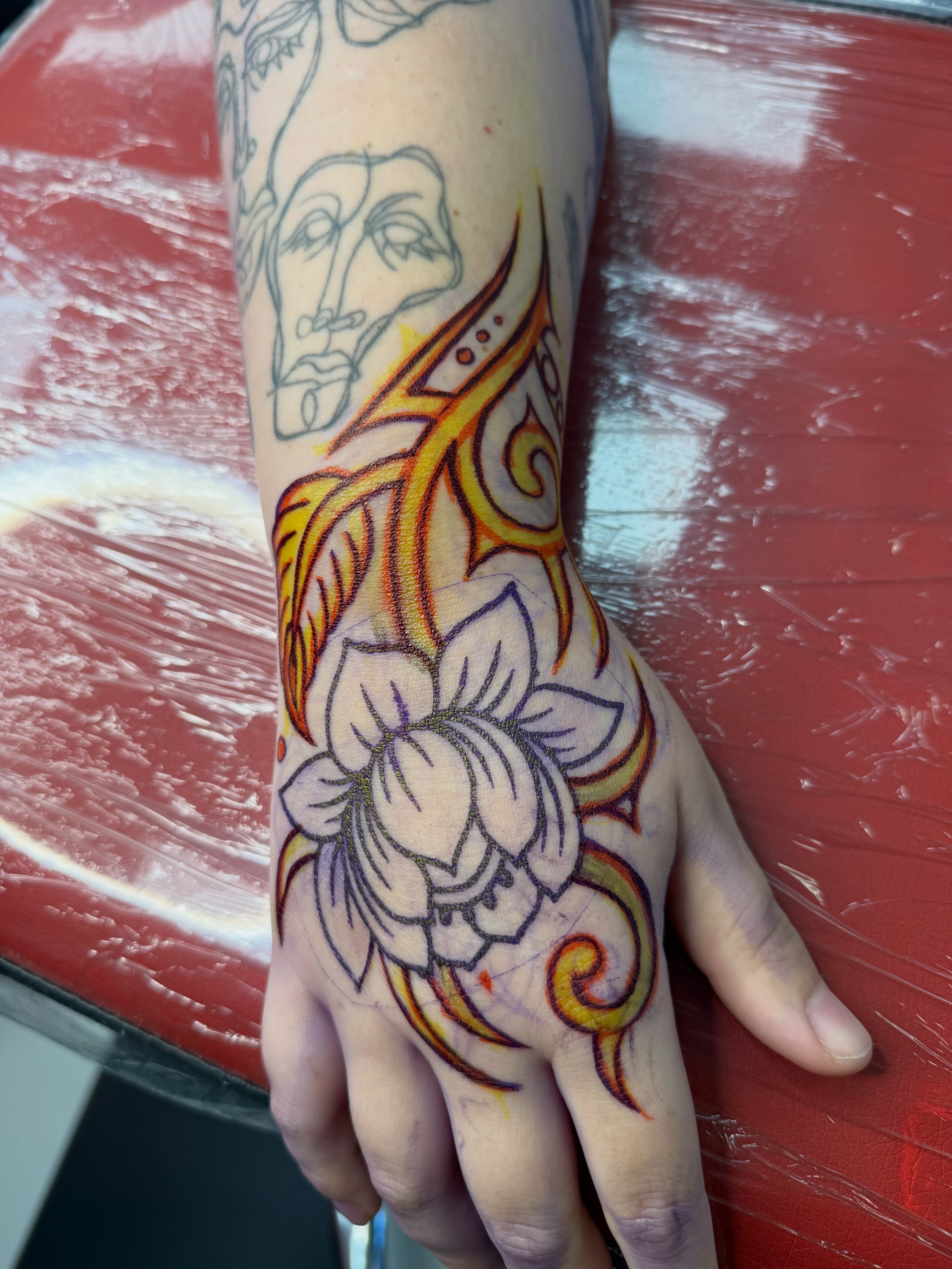 Lotus flower new school tattoo on the hand by Emma Eaton