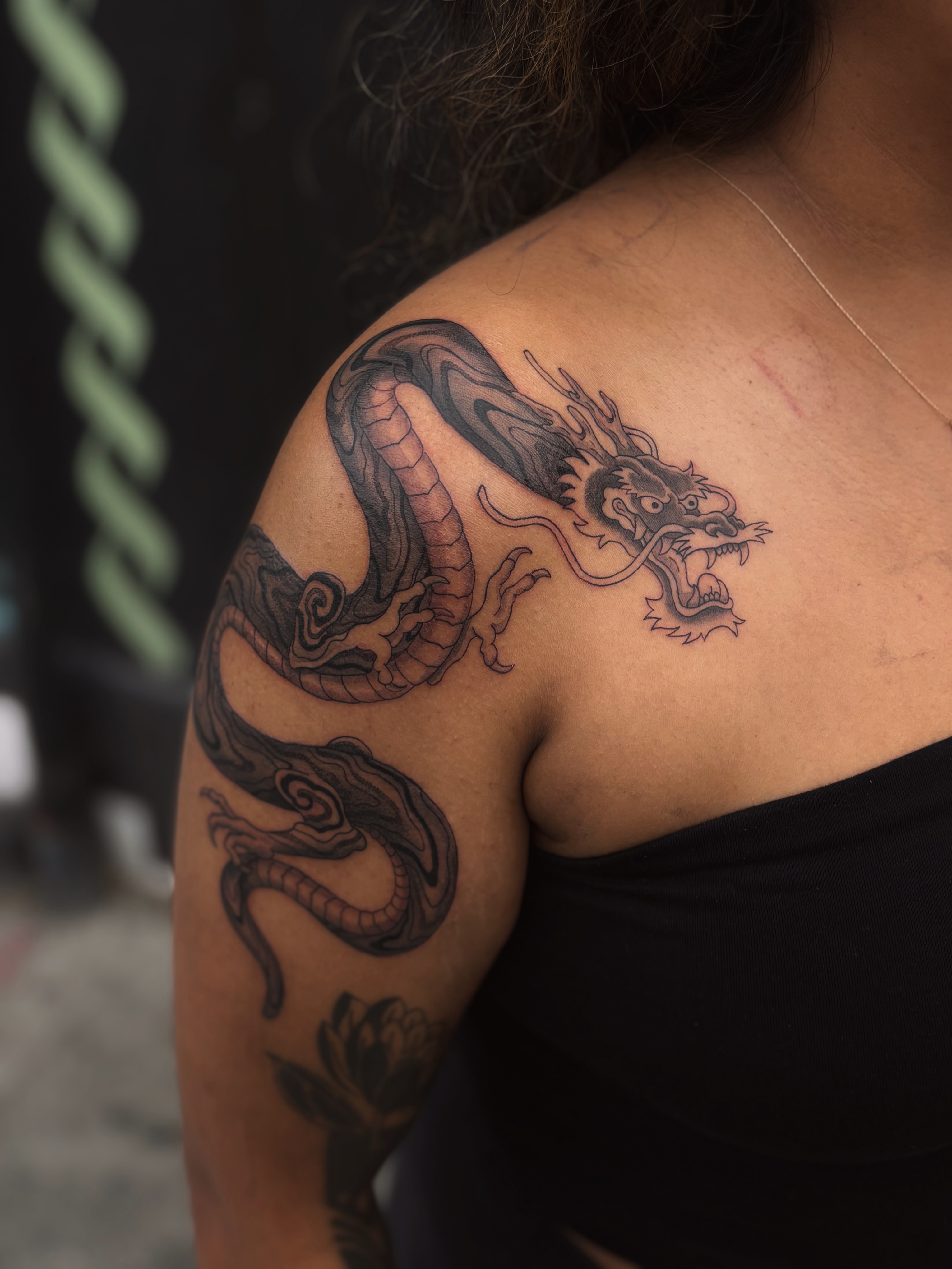 Dragon black and grey tattoo on the shoulder by Storm Smith