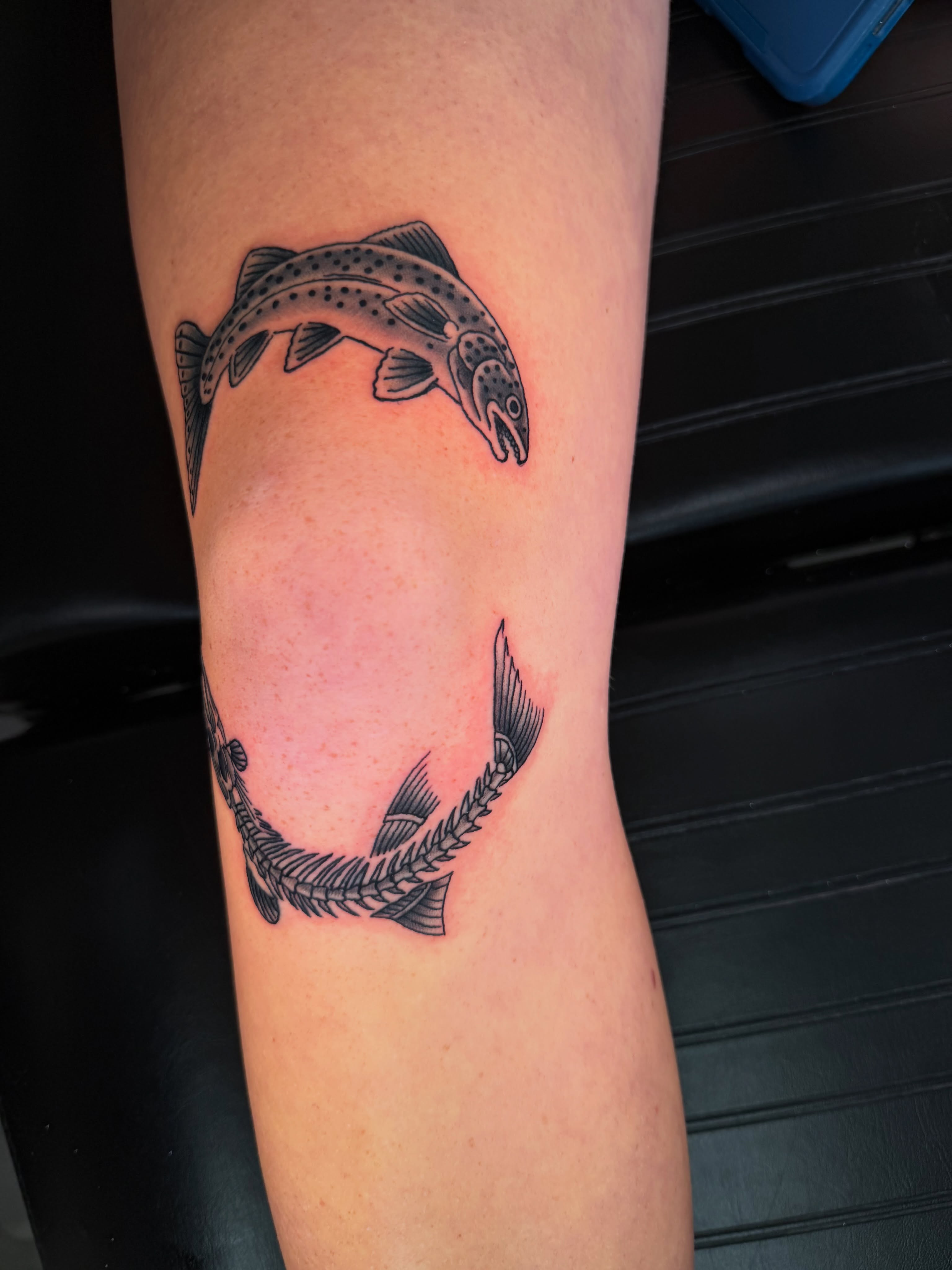 Leaping trout black and grey tattoo on the forearm by Beau Zeis