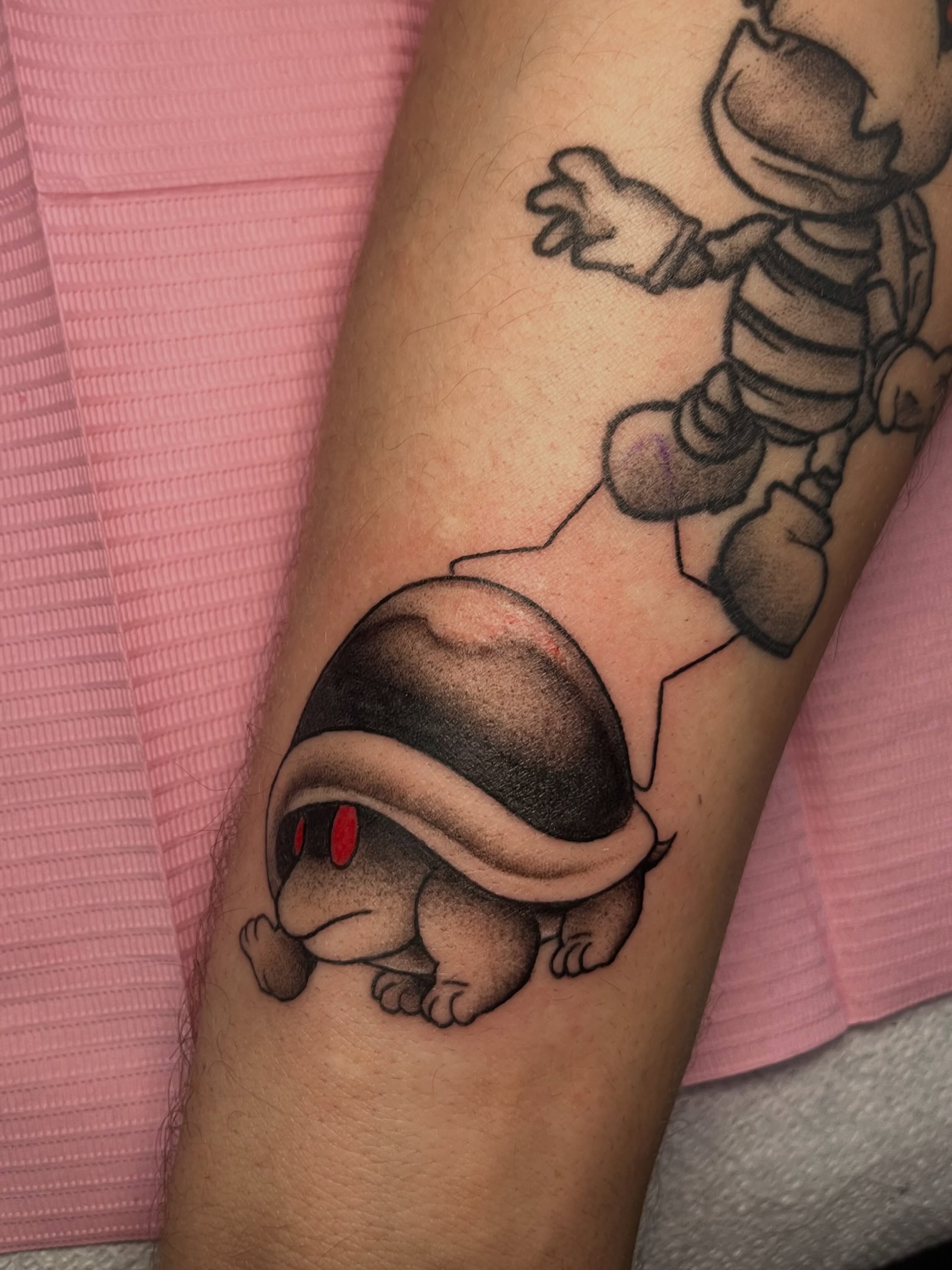 Turtle black and grey tattoo on the forearm by Hannah Hahn