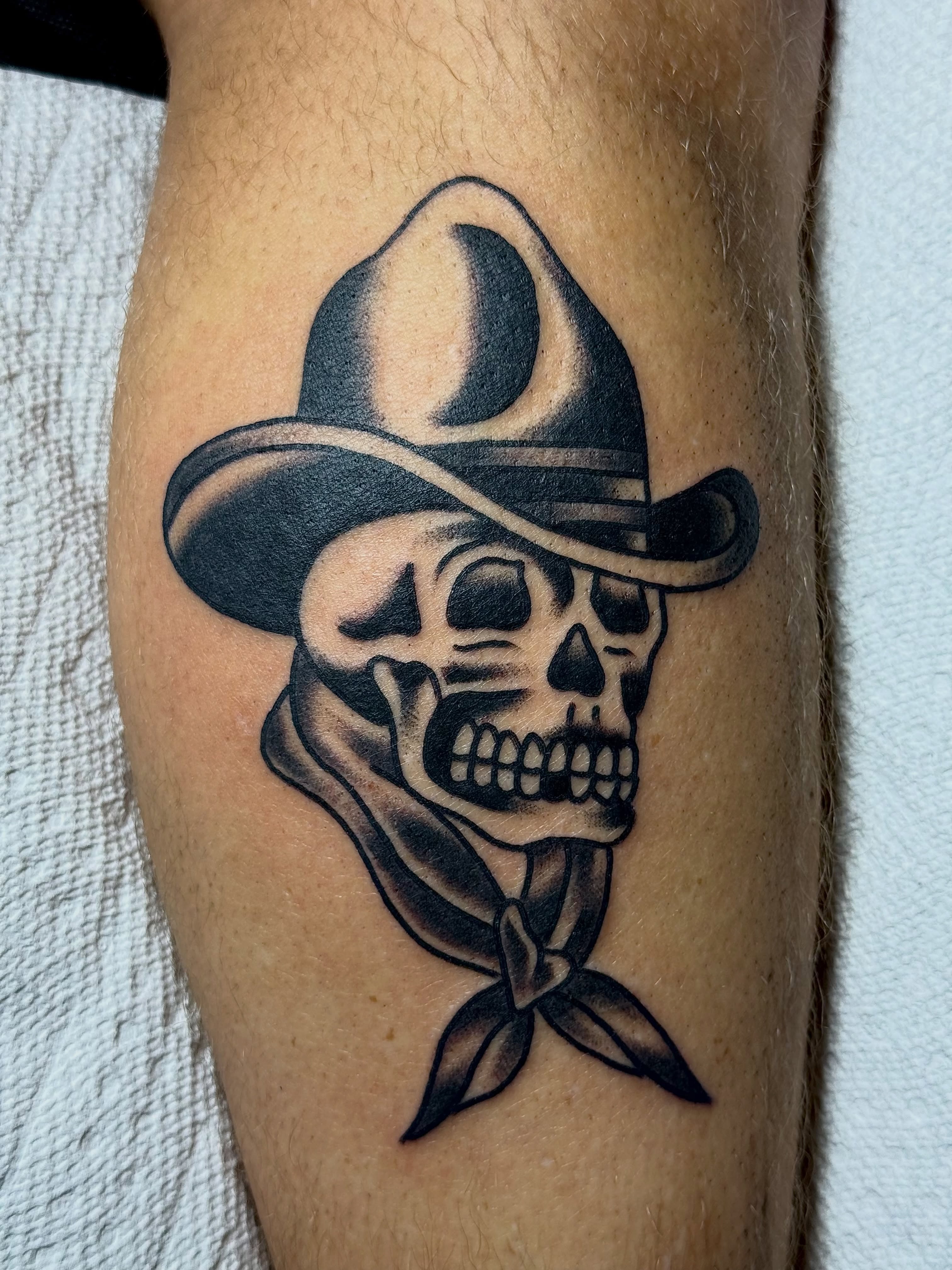 Cowboy skull American traditional tattoo on the forearm by Chuck Derek Whitaker