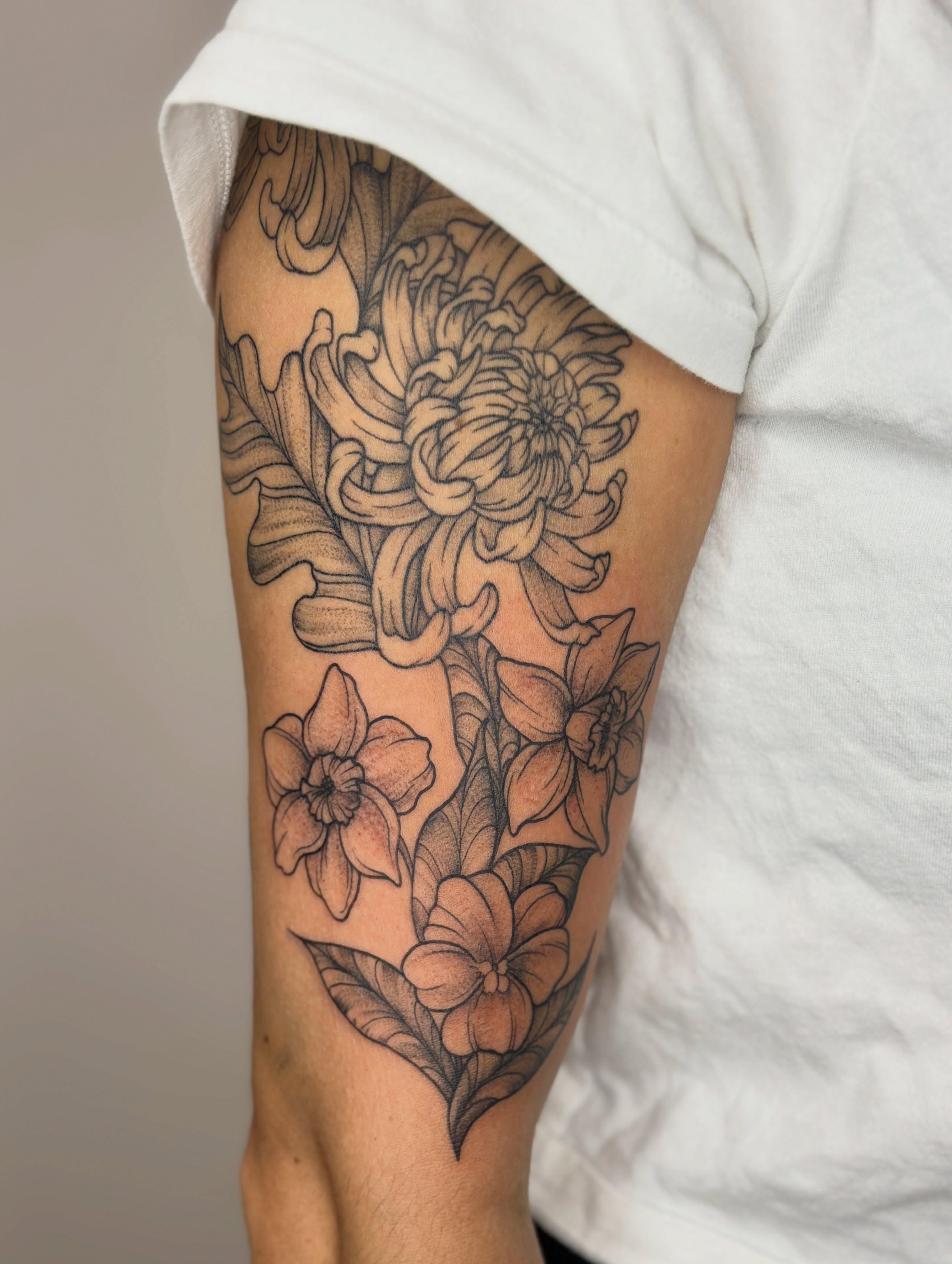 Chrysanthemum bouquet black and grey tattoo on the forearm by Gabrielle Brodman 🎀 Raleigh-Durham Tattoo