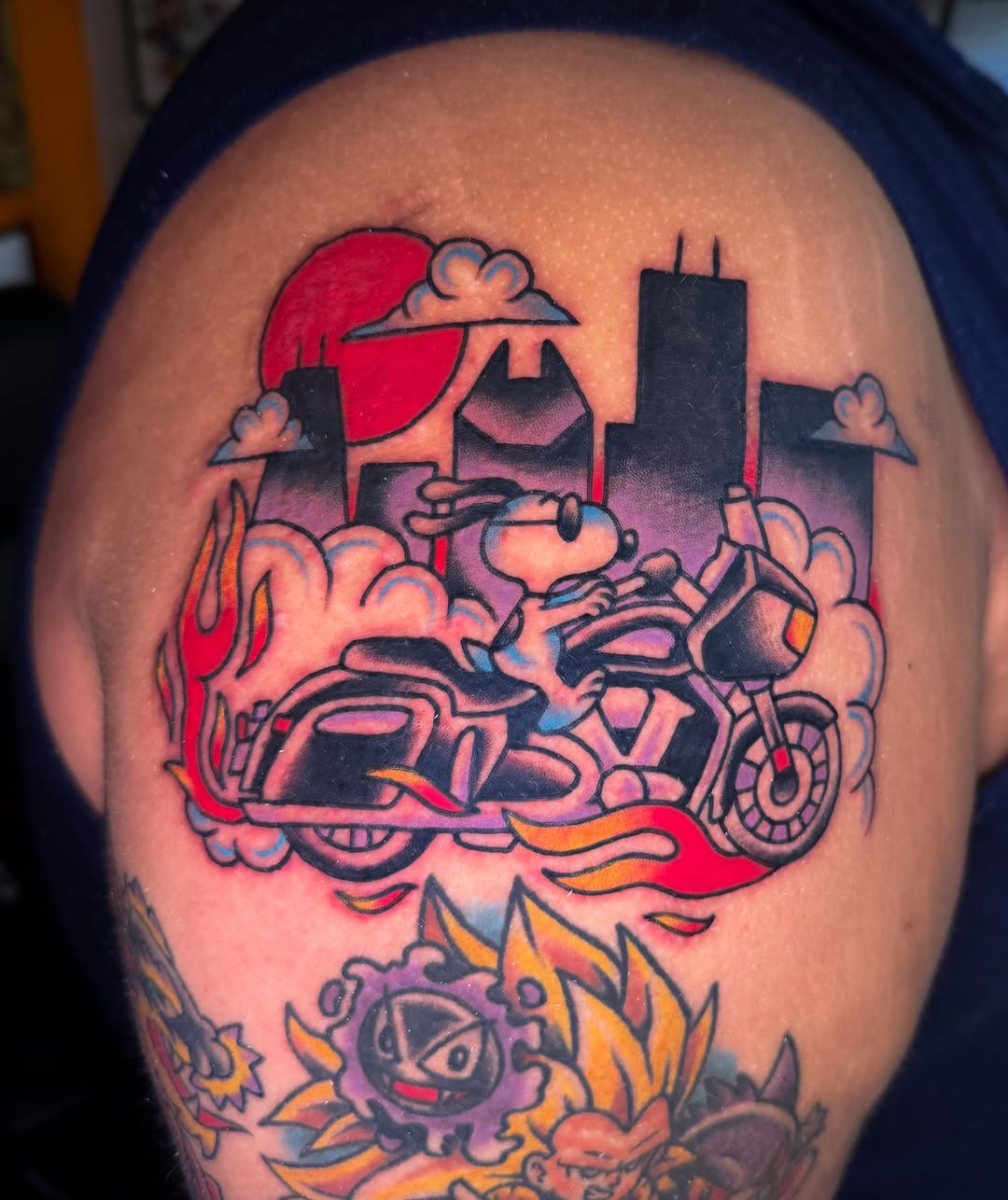 Snoopy on motorcycle American traditional tattoo on the shoulder by Louie Flores