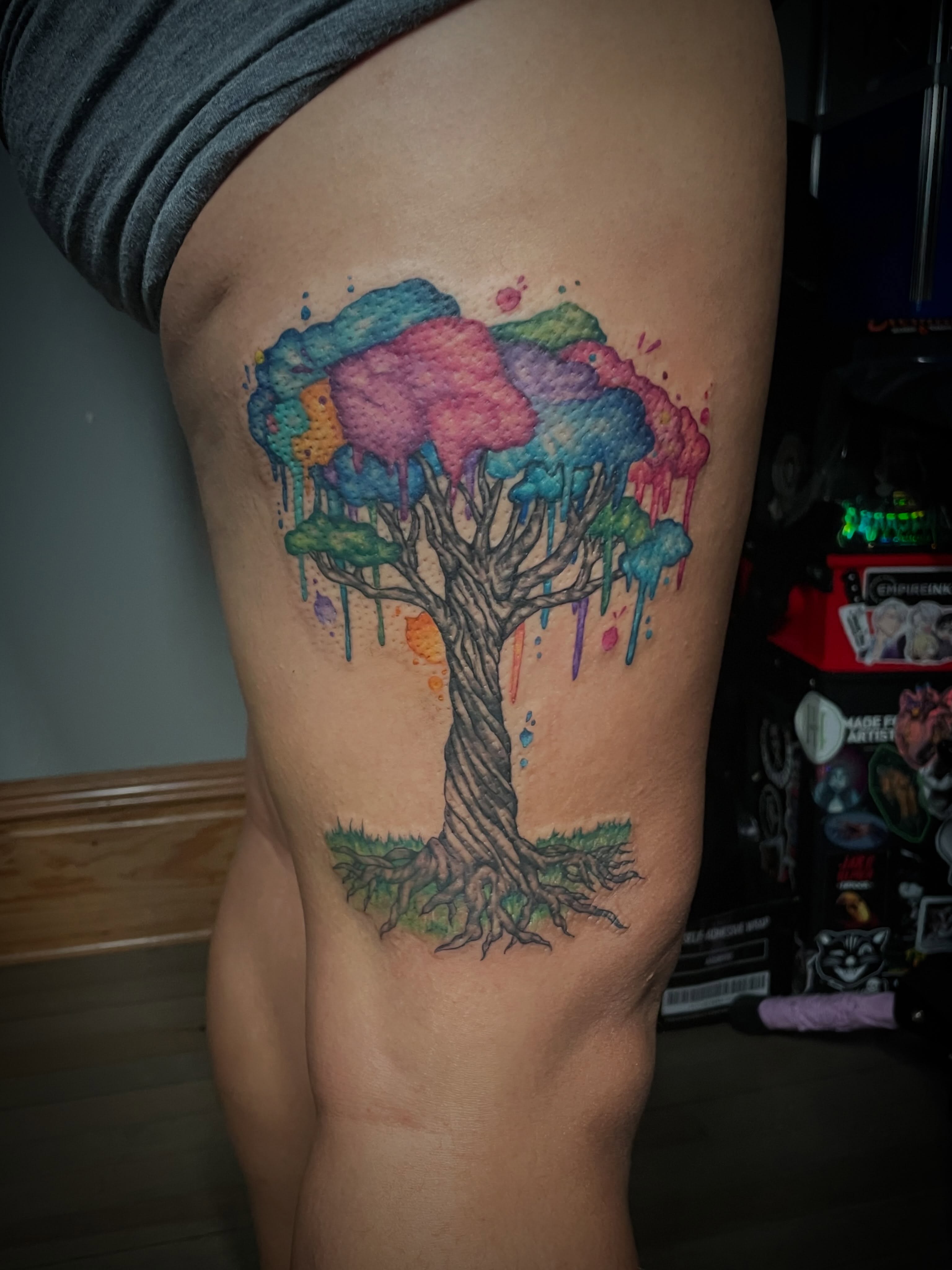 Watercolor tree watercolor tattoo on the thigh by Hannah Copeskey