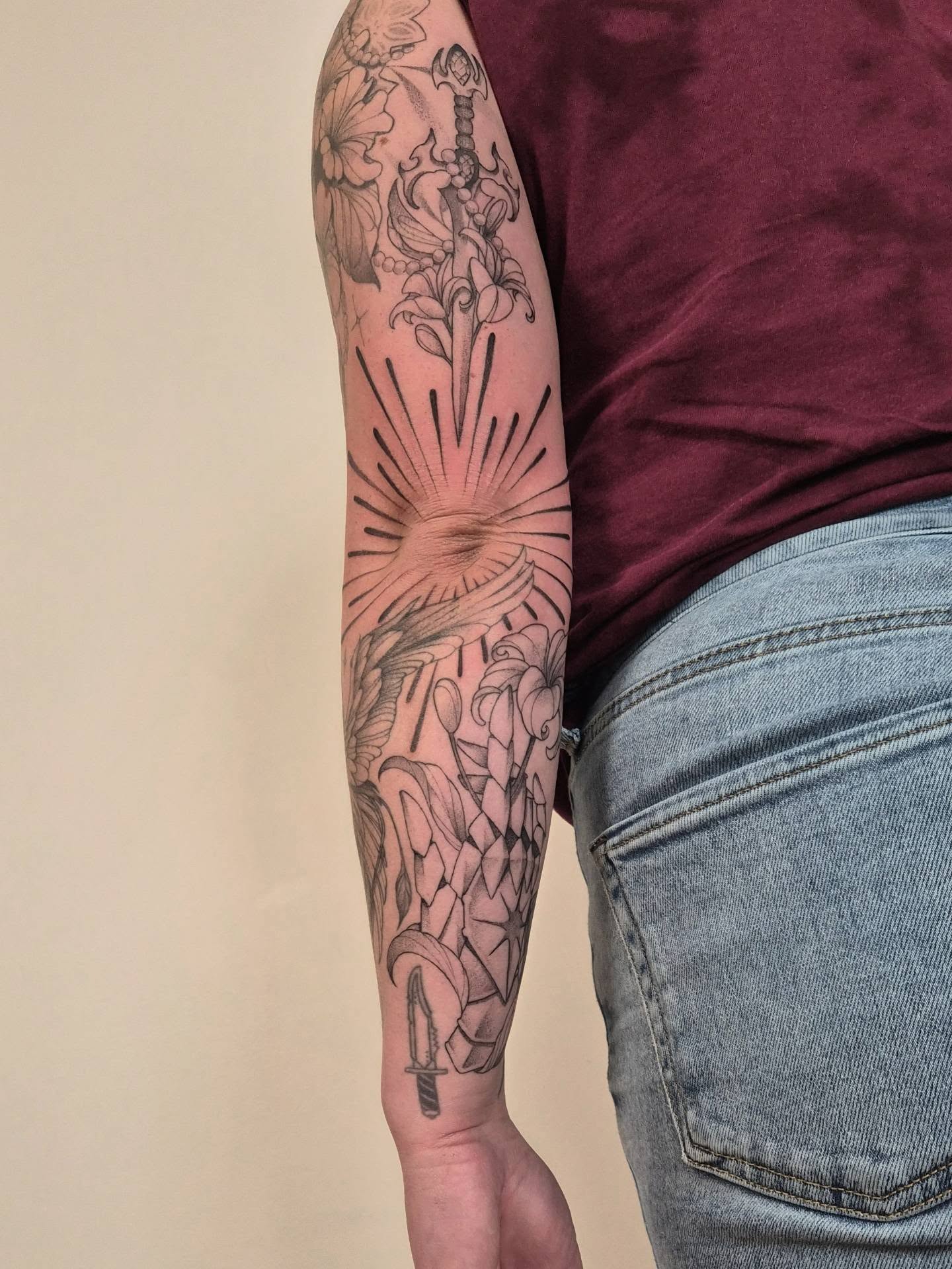 Sword and sunburst black and grey tattoo on the forearm by Sophorn Long (soapy)