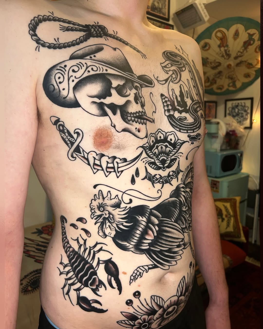 Skull with cowboy hat and cigarette ignorant tattoo on the torso by Olivia Marie
