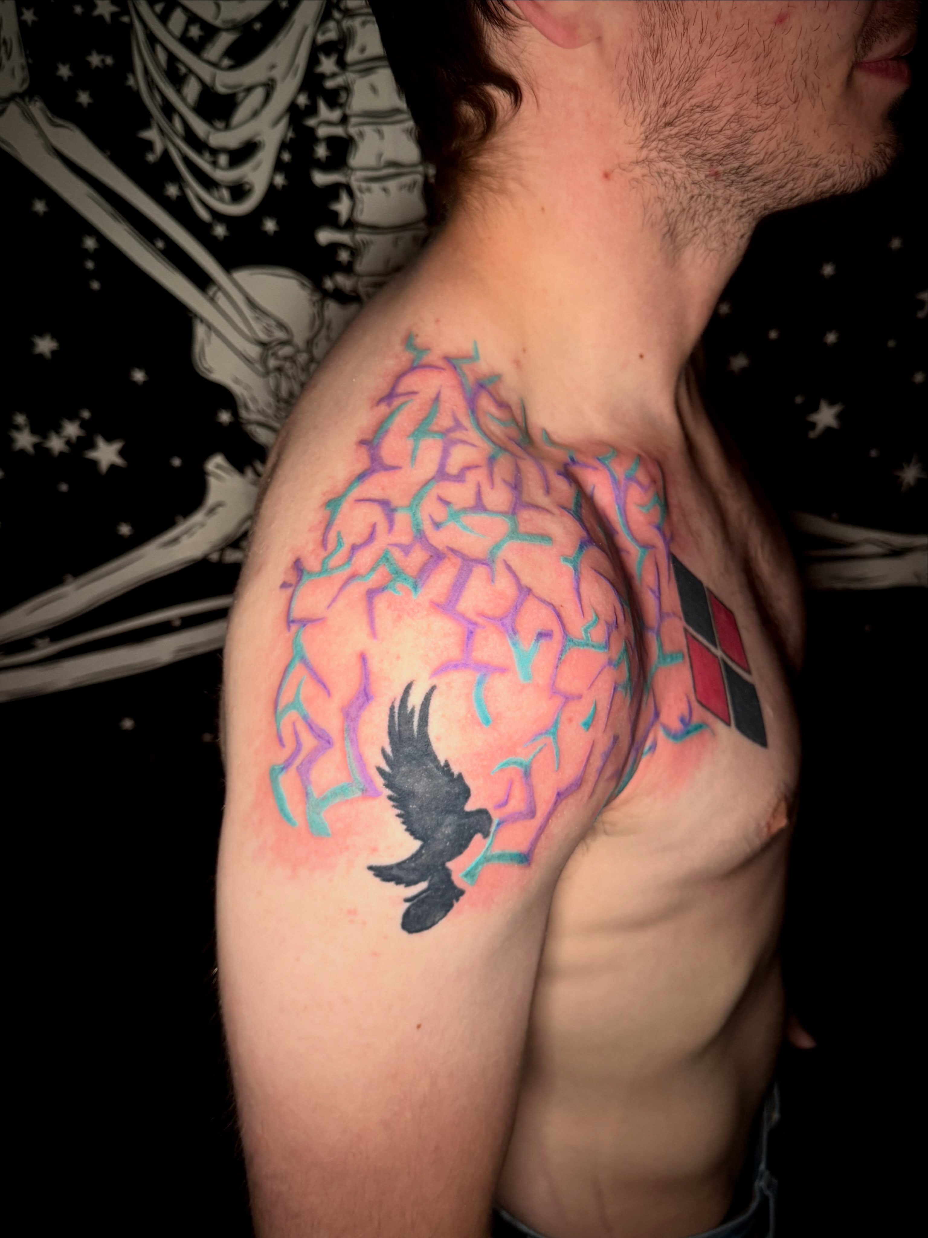 Crow and cracked brain geometric tattoo on the shoulder by Mikey
